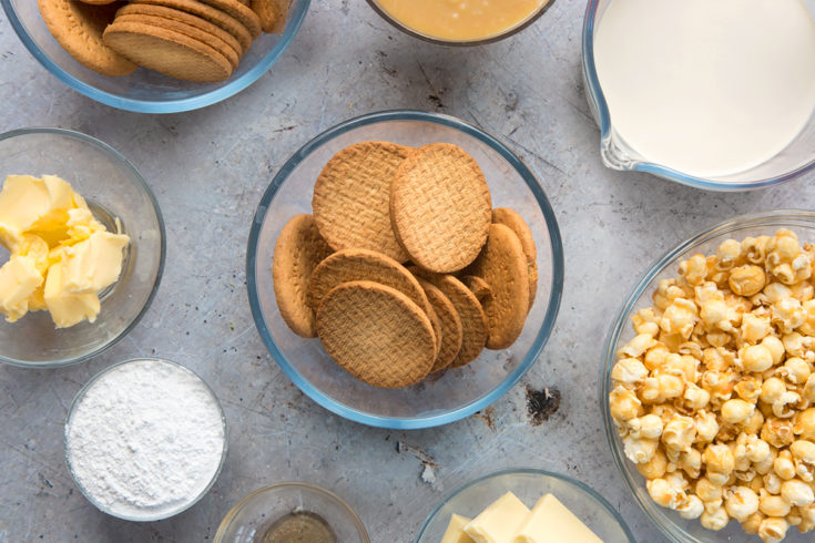 overhead view of a clear bowl with digestive biscuits in surrounded by ingredients in clear bowls.