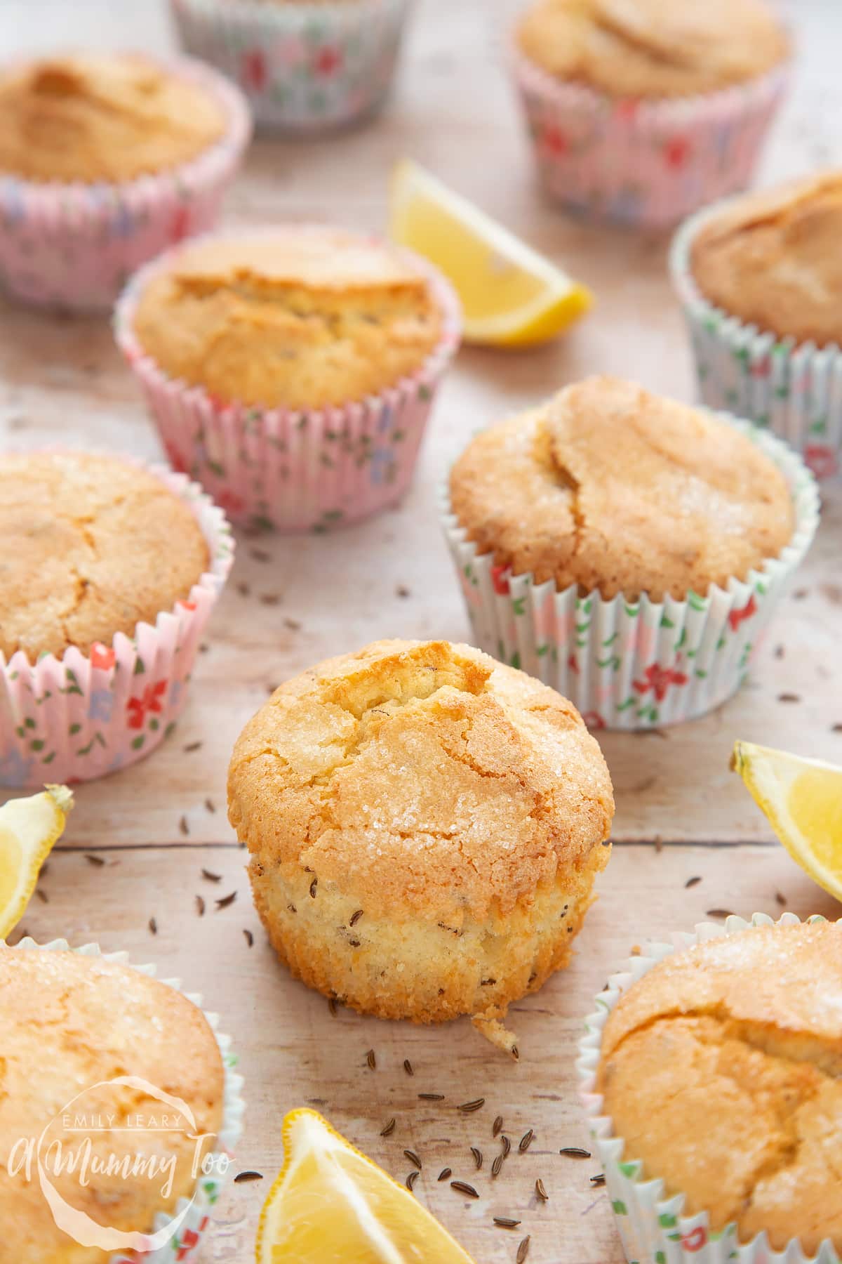 Front angle shot of Caraway muffins and lemons with a mummy too logo in the lower-left corner