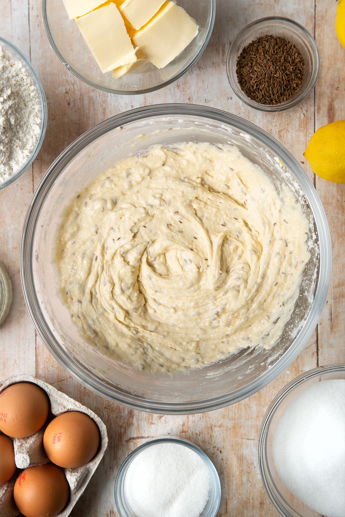 Overhead shot of muffin mix in a large clear bowl