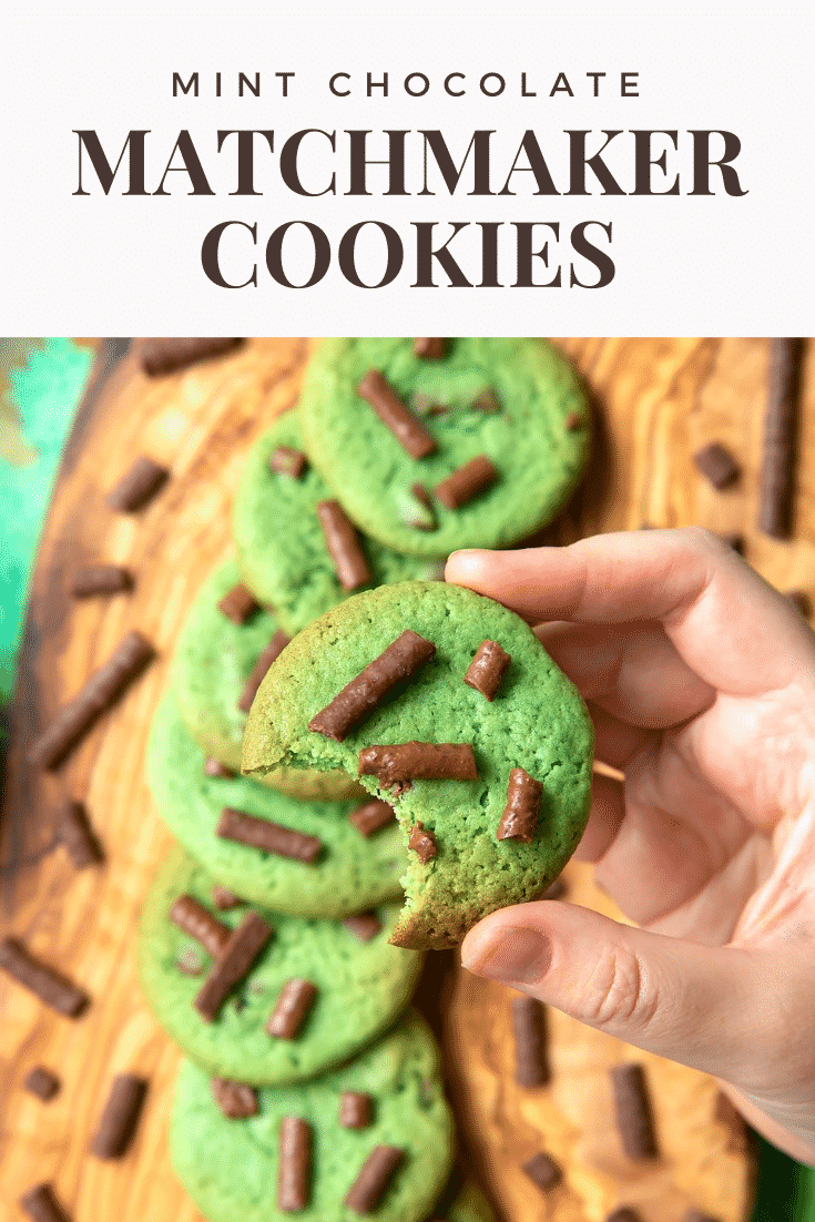 Hand holding a Matchmaker cookie above more cookies arranged on a wooden board. Caption reads: Mint chocolate Matchmaker cookies