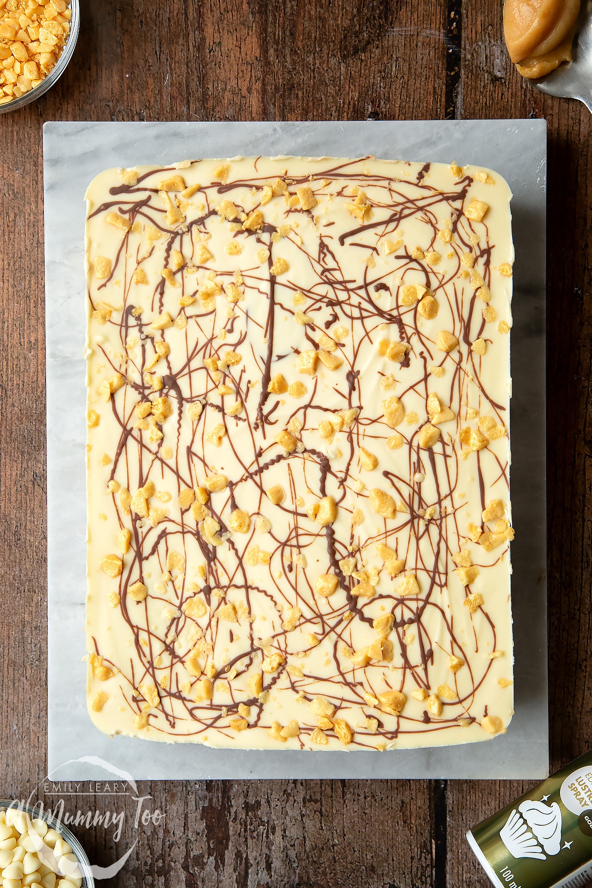 Overhead shot of the finished cake on a baking sheet on top of a dark wooden table.