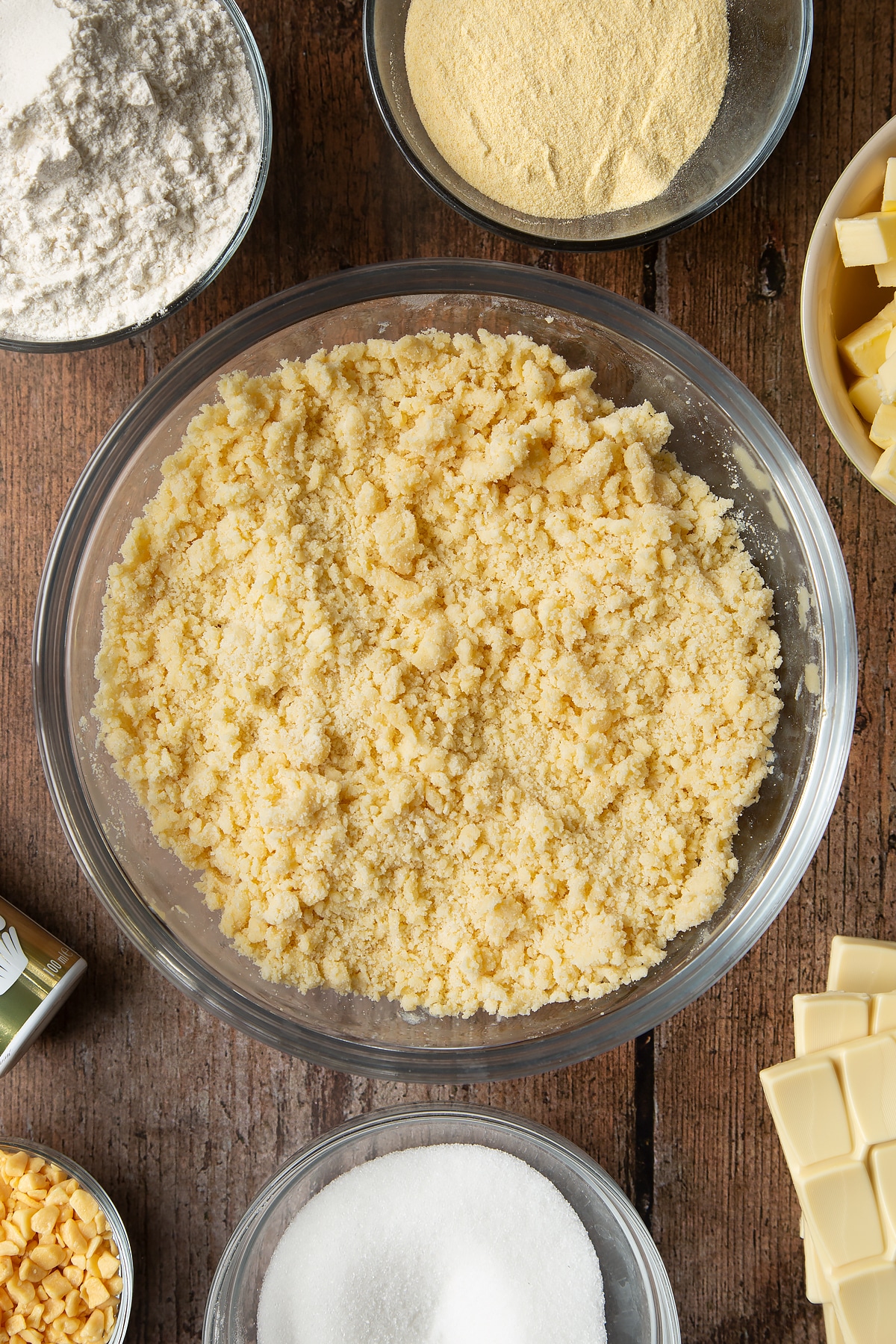 Overhead shot of crumbs dough in a large clear bowl
