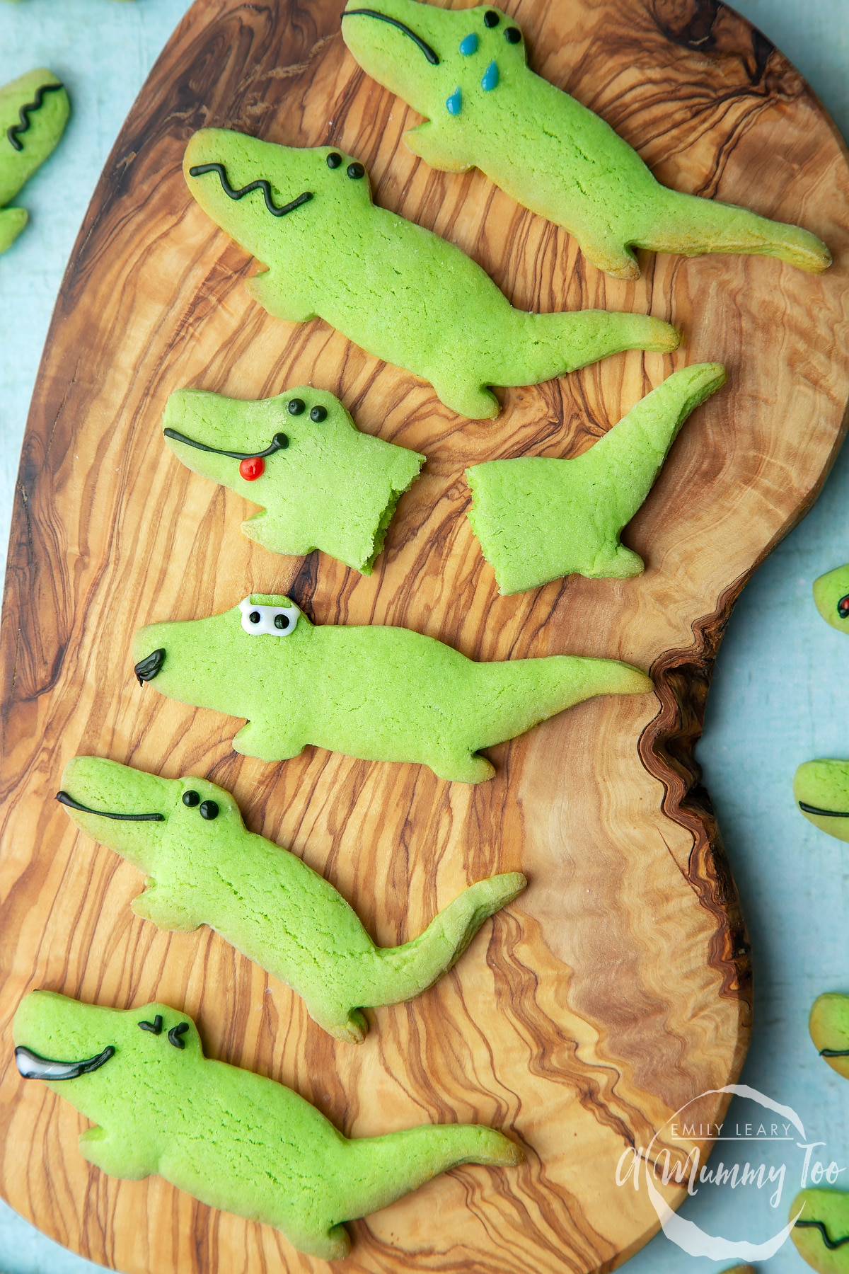 Finished crocodile cookies on a wooden board.