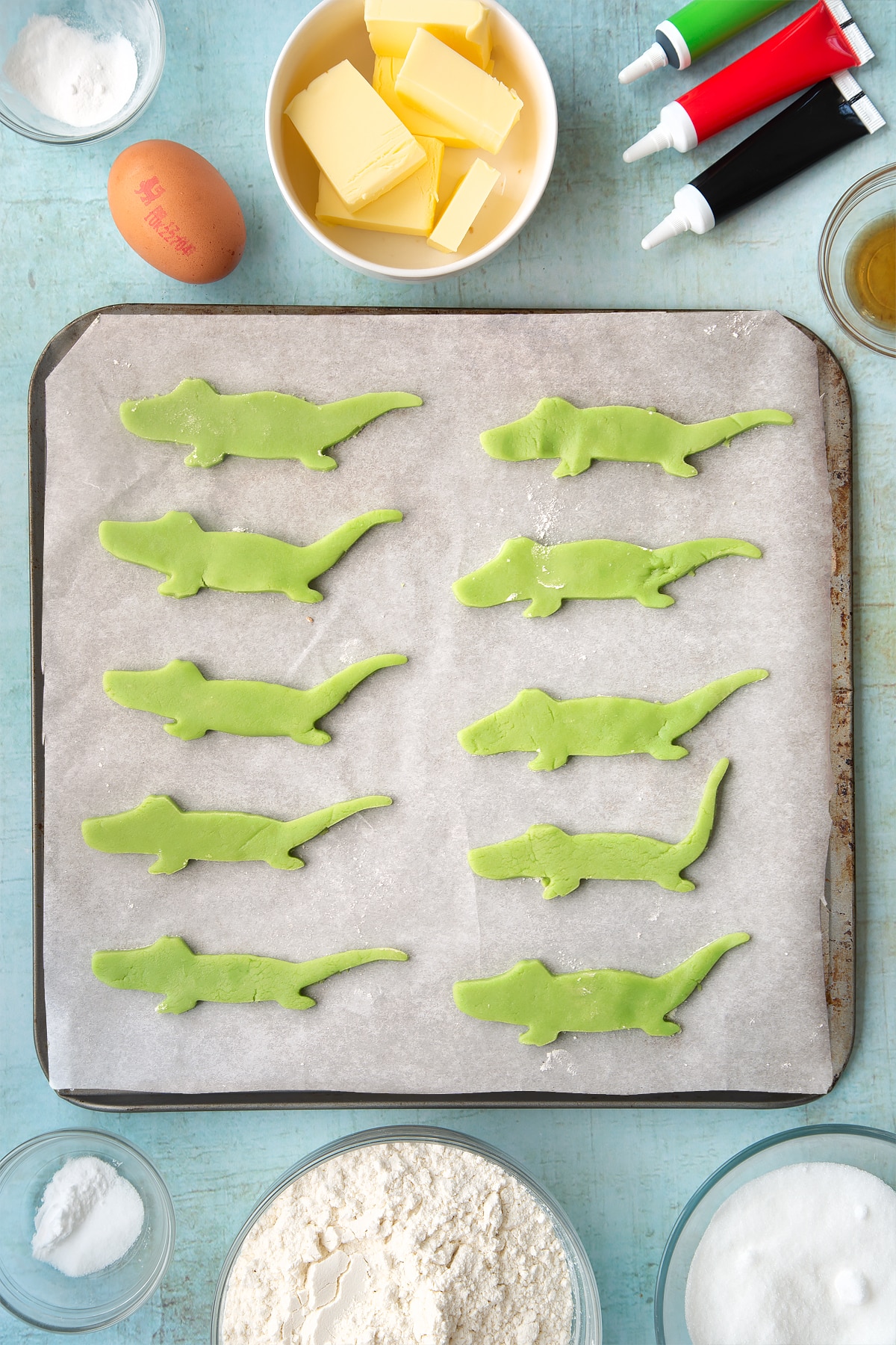 Cut out crocodiles made from pastry laid on a baking sheet.
