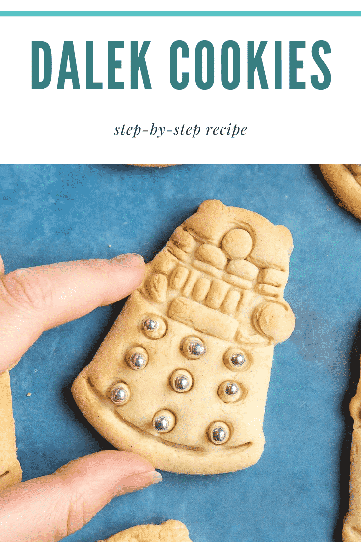 Hand holding a Dalek cookies decorated with silver candy balls. Caption reads: Dalek cookies step-by-step recipe