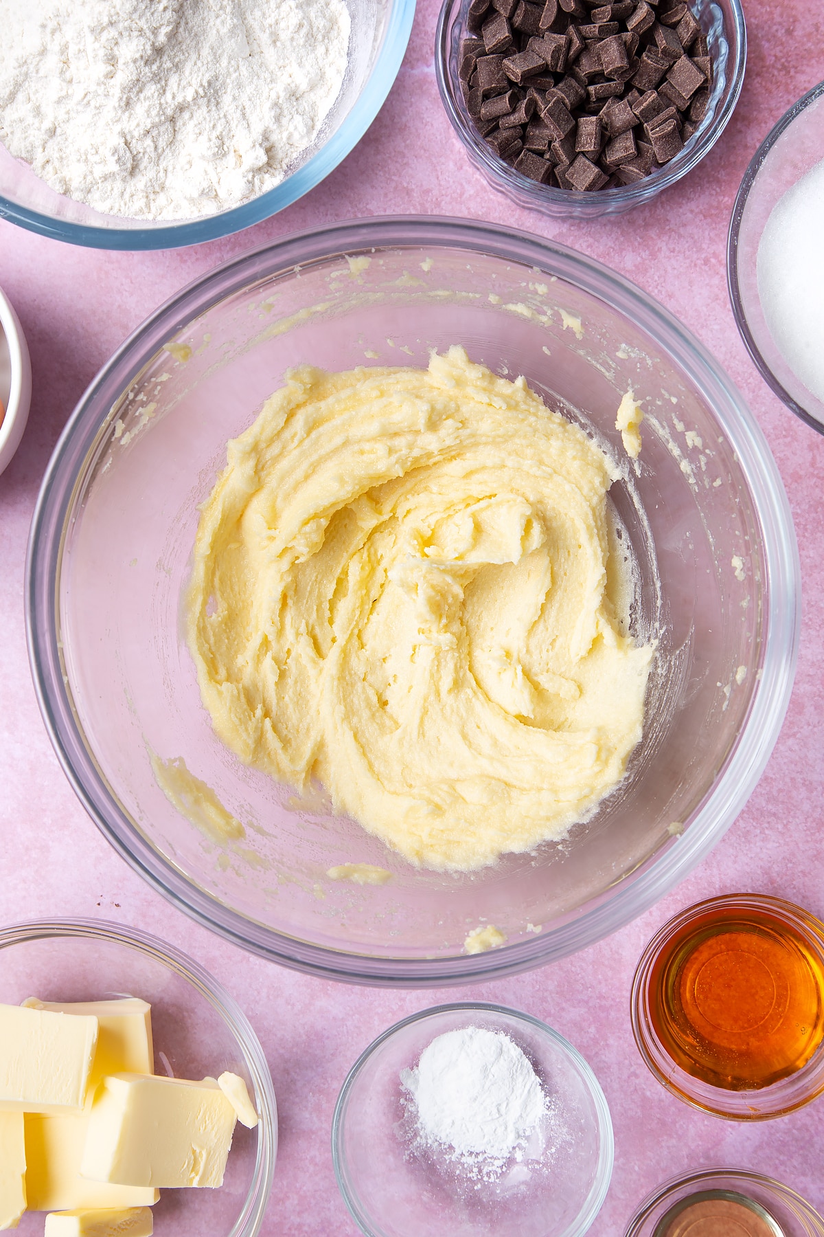 Overhead shot of fluffed butter in a large clear bowl