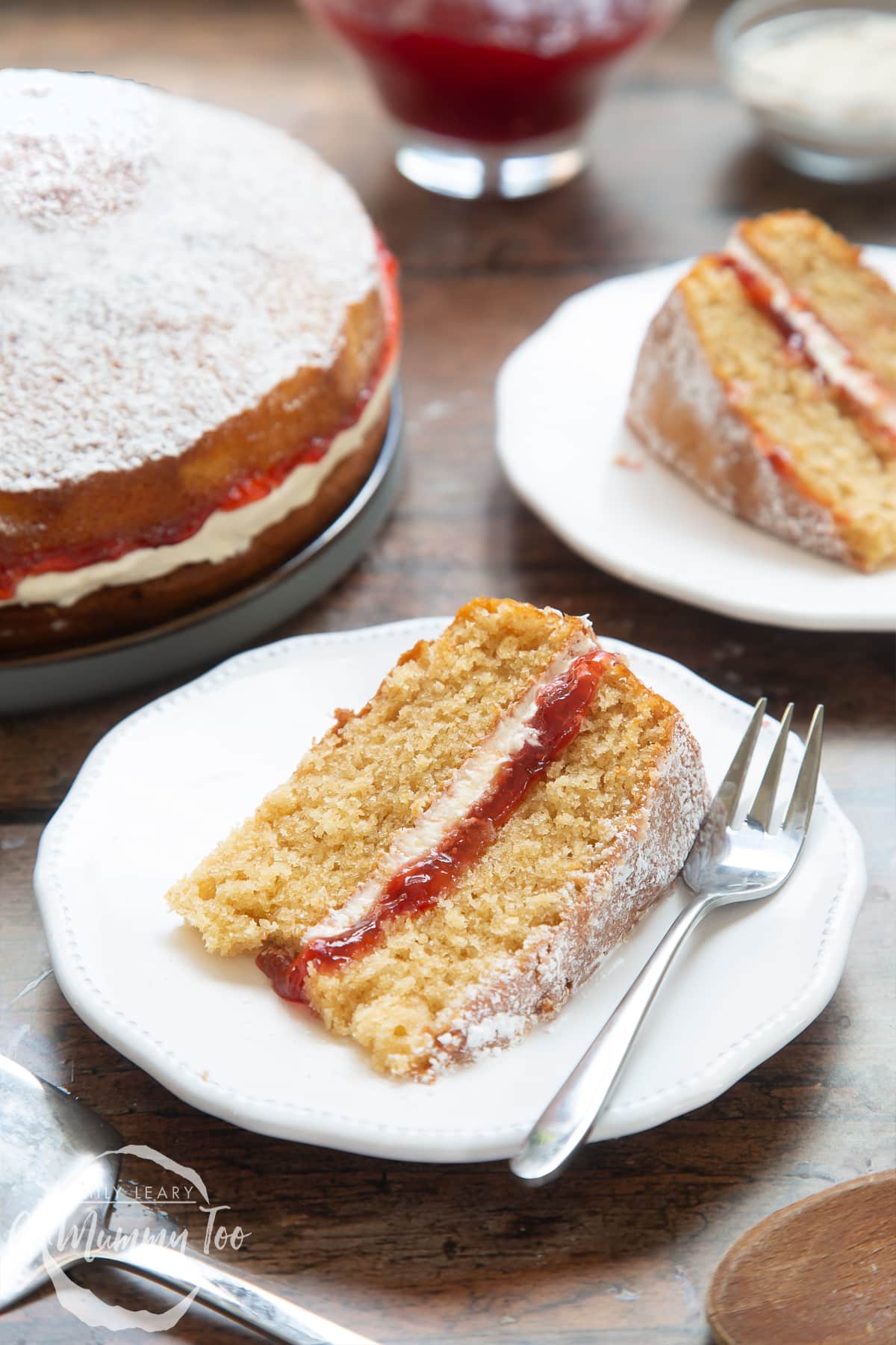 A slice of golden syrup sponge cake on a white decorate plate with a cake fork on the side.