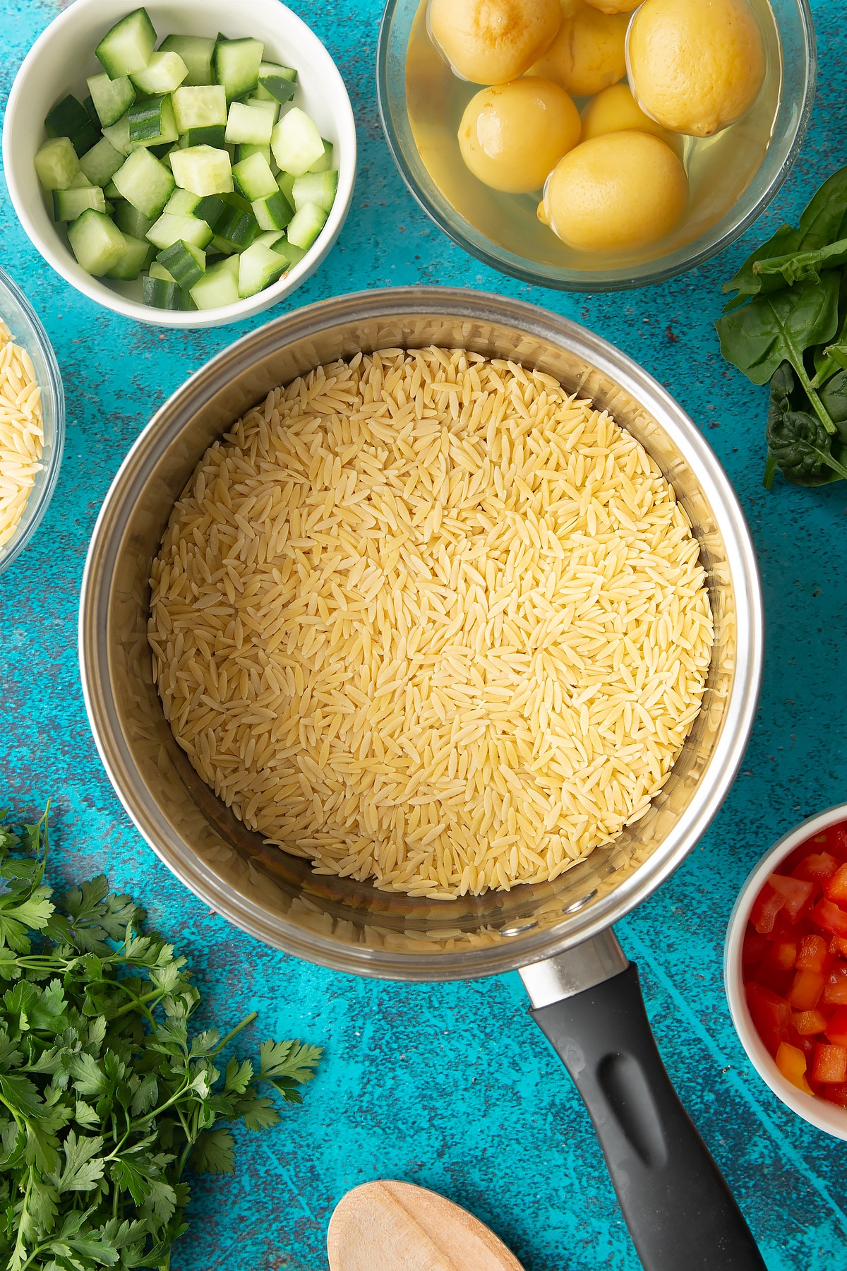 Dried orzo in a saucepan.