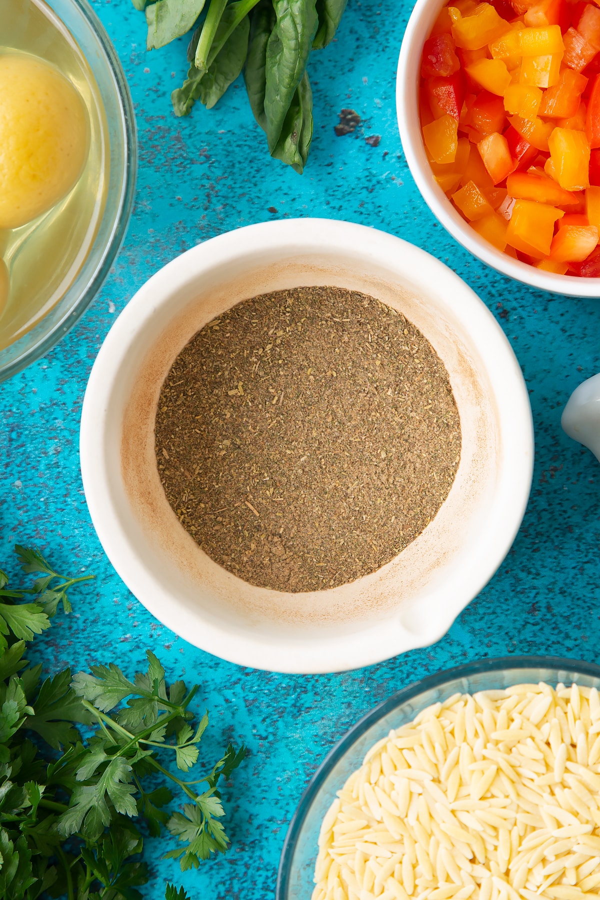 Ground herbs and spices in a mortar.