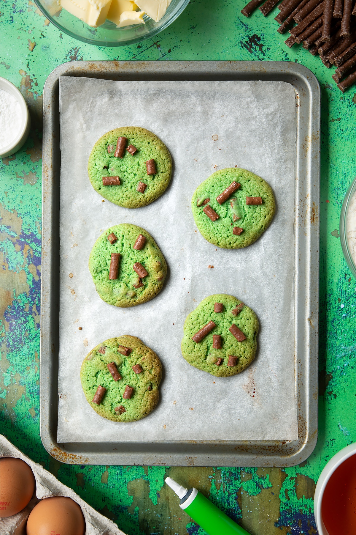 Matchmaker cookies on a lined baking tray. They have been topped with Matchmaker pieces.
