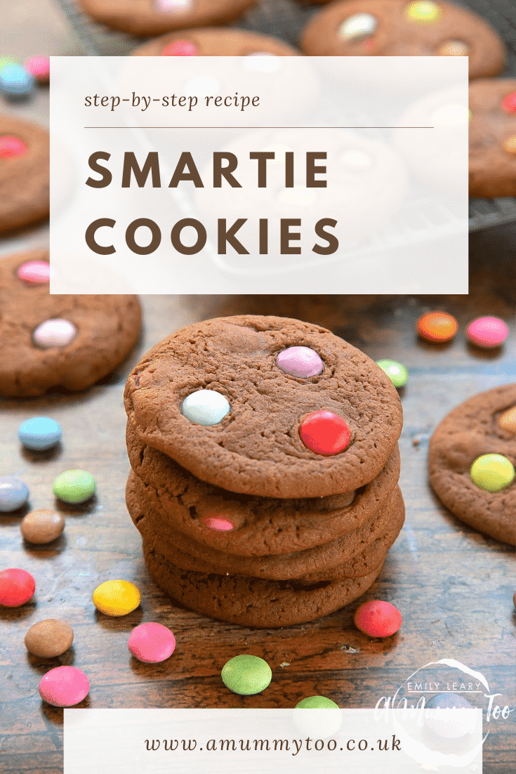 Smartie cookies stacked up on a dark wooden surface. Caption reads: step-by-step recipe Smartie cookies