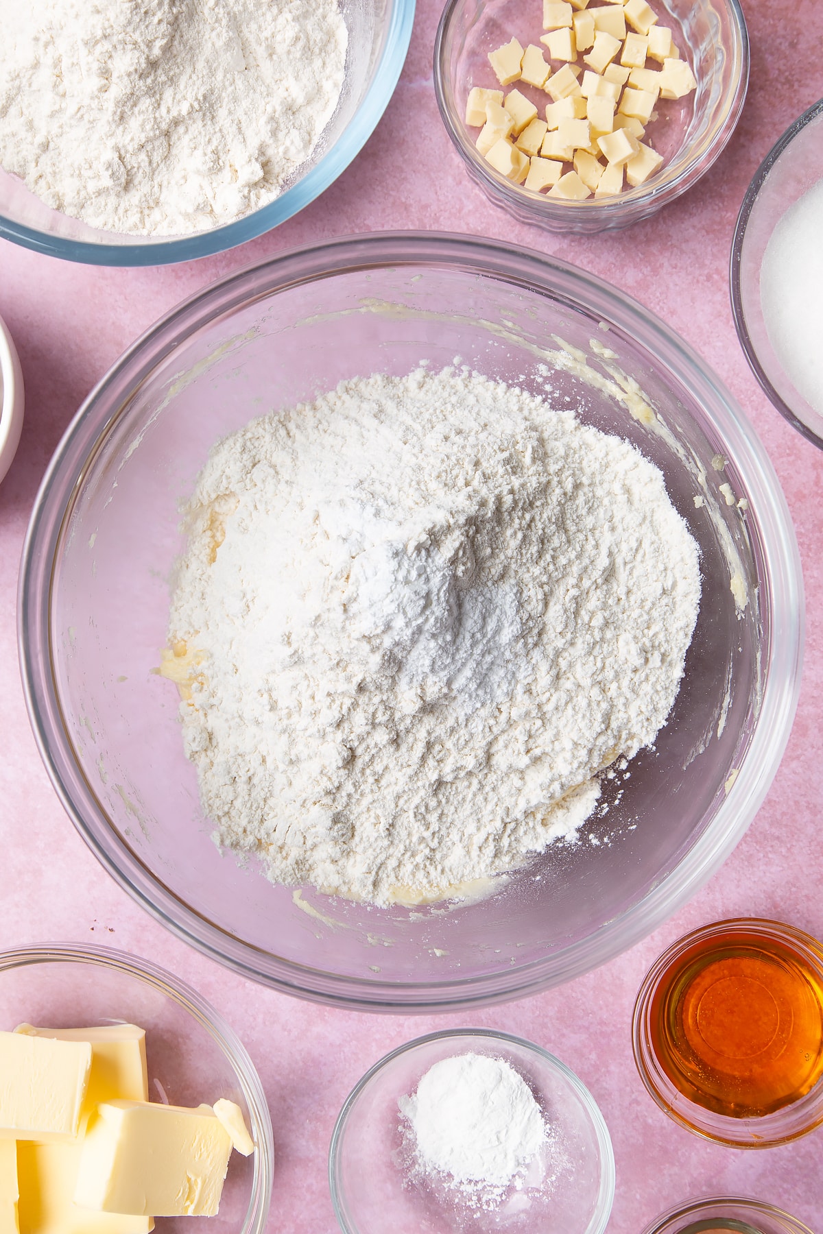 Overhead shot of flour on top of butter mix and an egg in a large mixing bowl