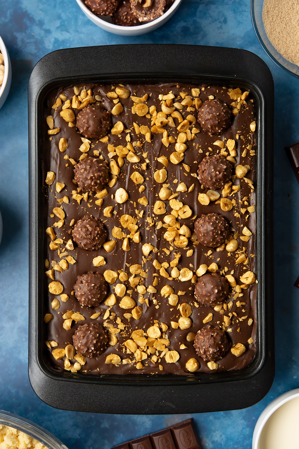 Finished and chilled Ferrero Rocher slice in a tray.