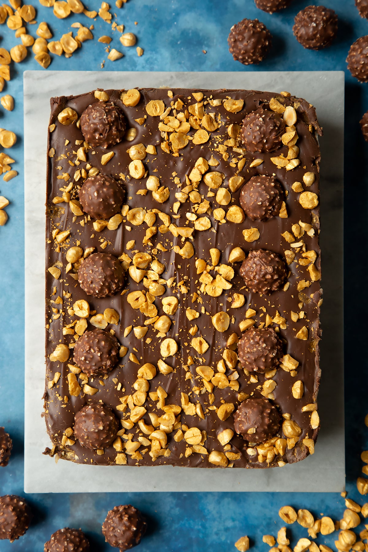 Marble board with large Ferrero Rocher slice.