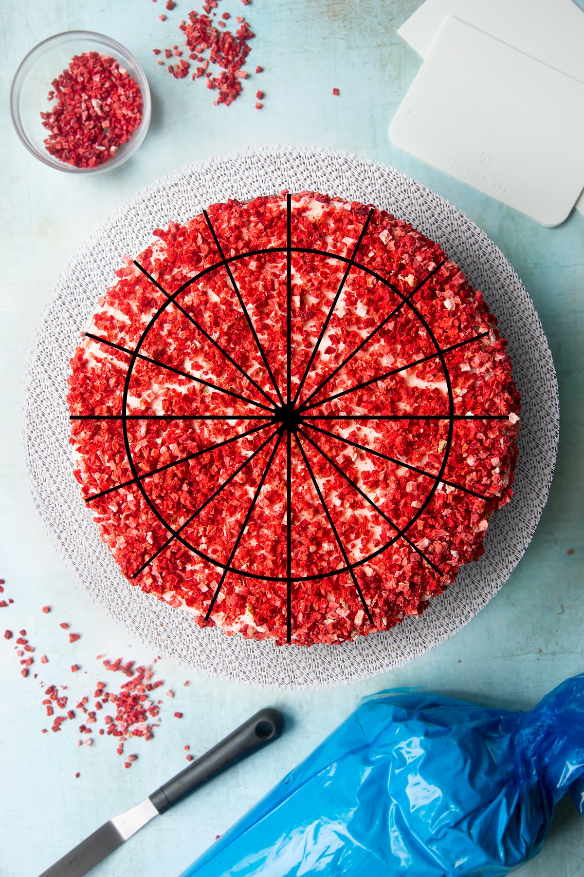A pink ombre cake shown from above. wedge lines and a smaller circle have been super imposed on top to show how the cake could be cut.