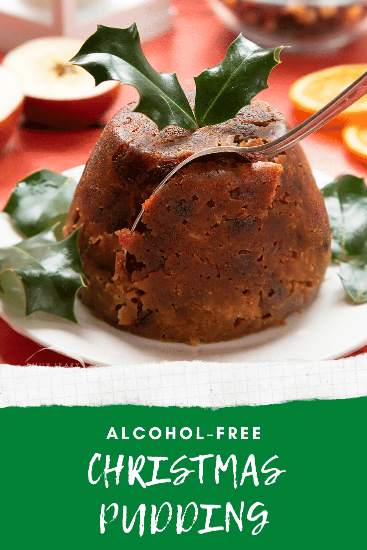 Front angle shot of Christmas pudding with a fork going into the side. At the bottom of the image there's some text describing the image for Pinterest.