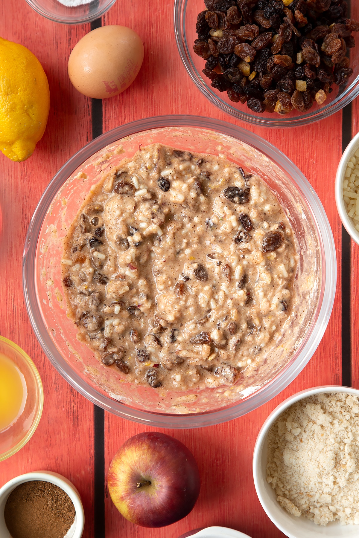 Overhead shot of christmas pudding batter in a large clear bowl