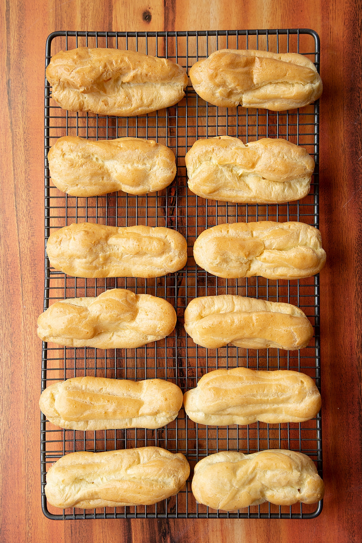 Baked choux patstry cooling on a wire rack.