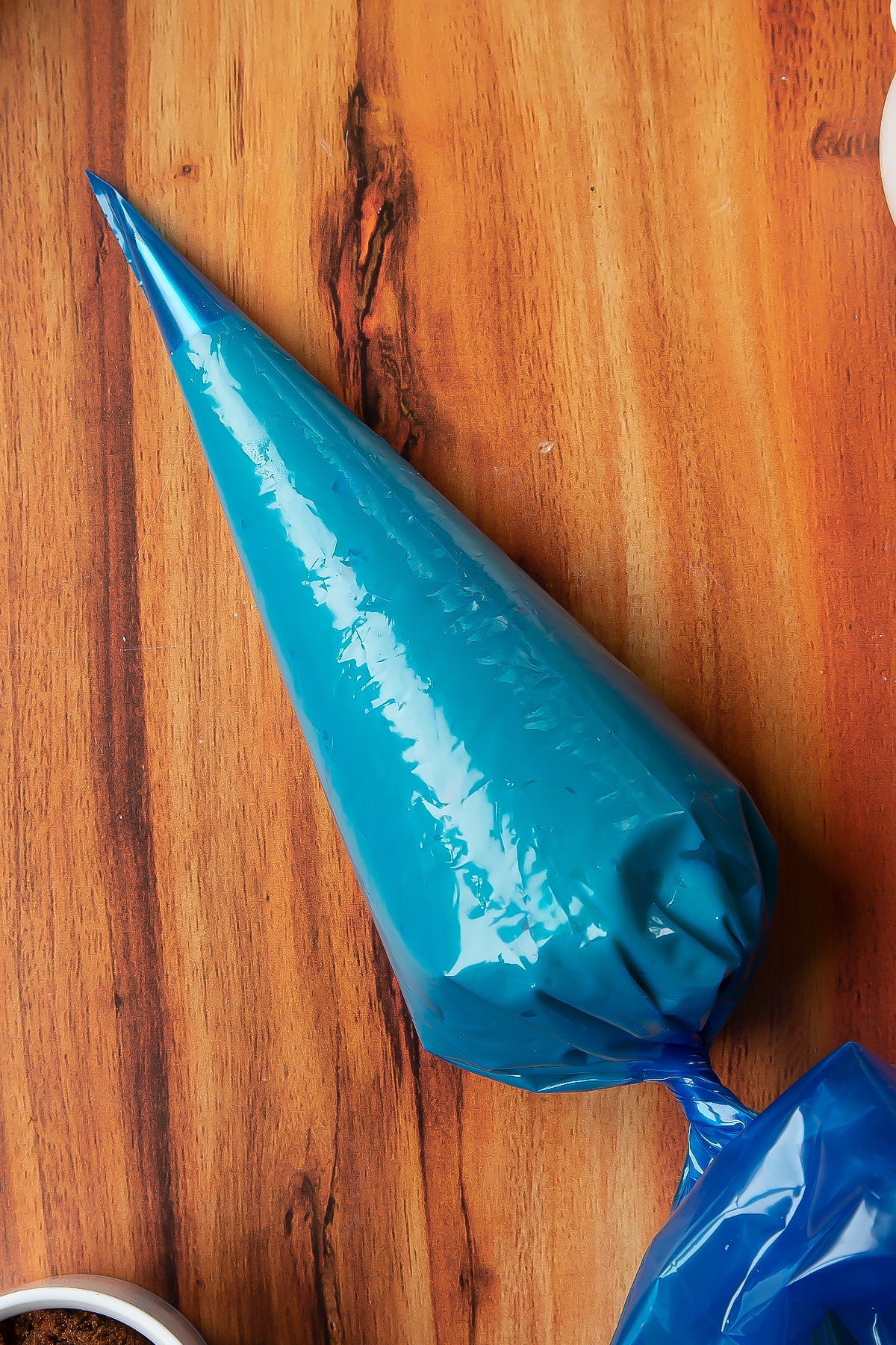 Overhead shot of a piping bag filled with choux pastry.