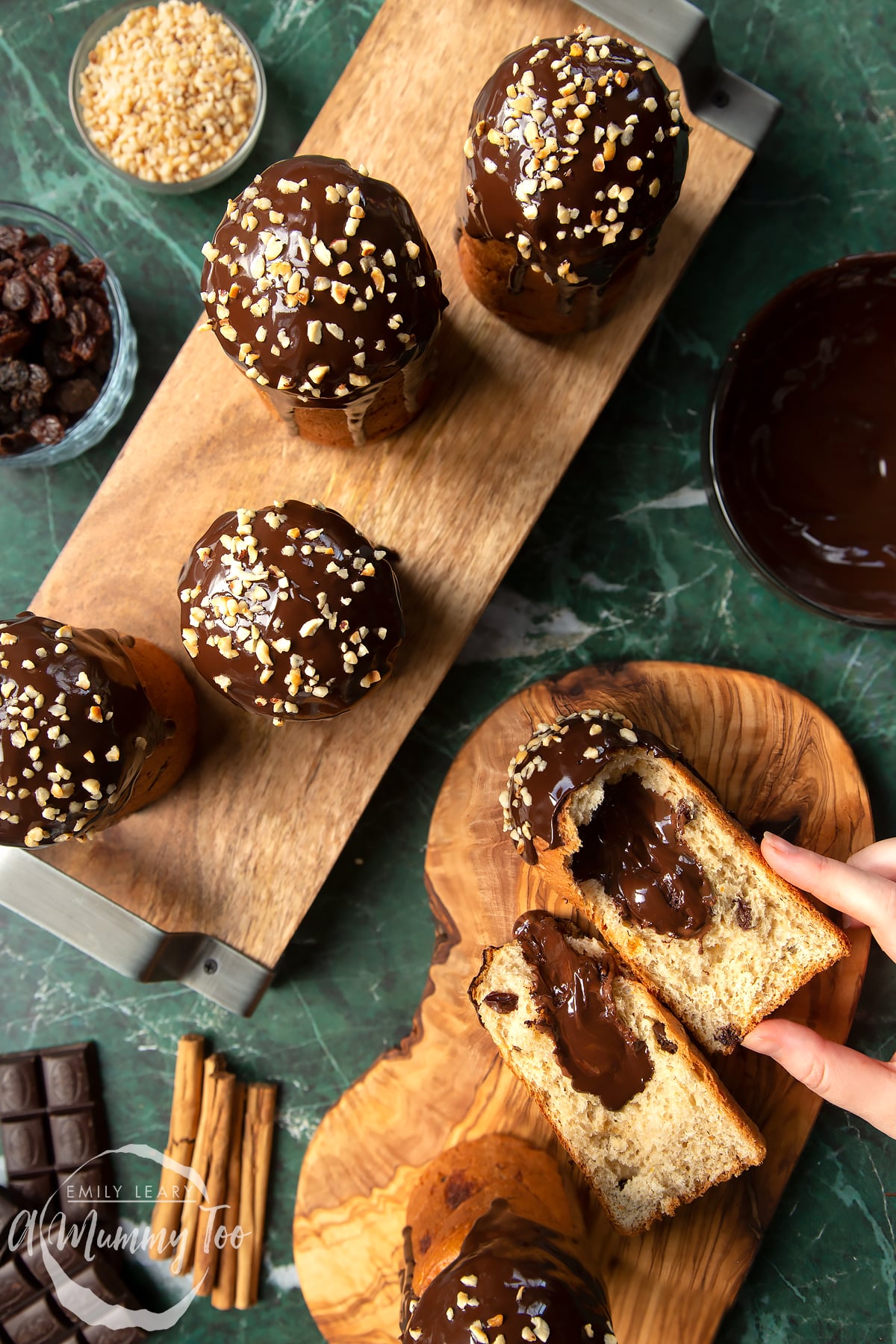 Nutella panettone on two wooden boards. A hand reaches for a panettone, which has been torn open to reveal the Nutella inside.