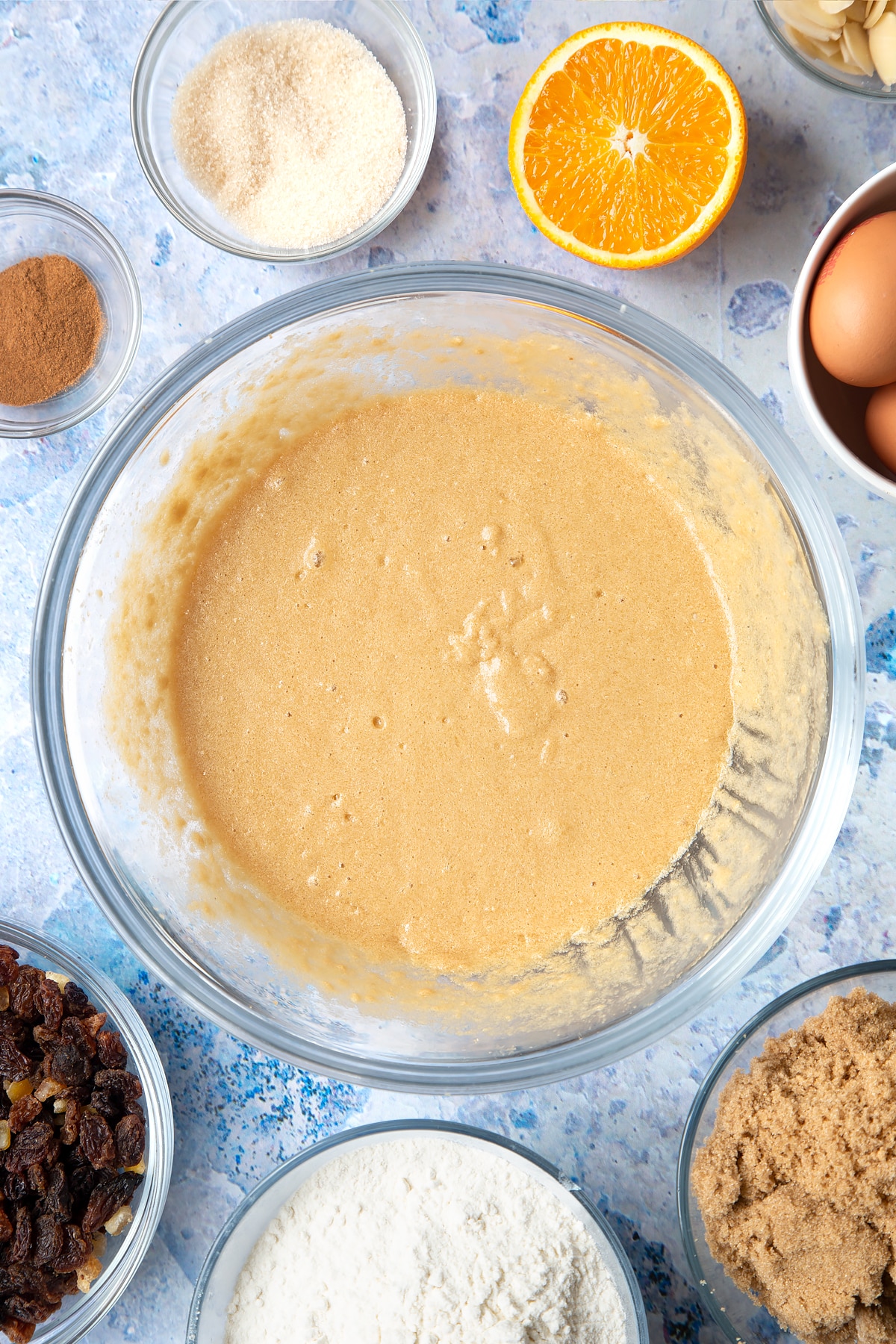 Overhead shot of muffin batter in a large clear bowl