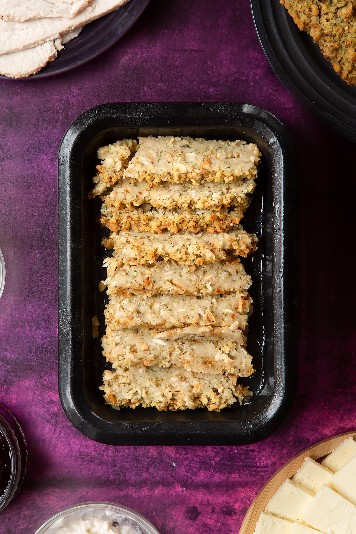 Overhead shot of sliced stuffing in a greased oven tray