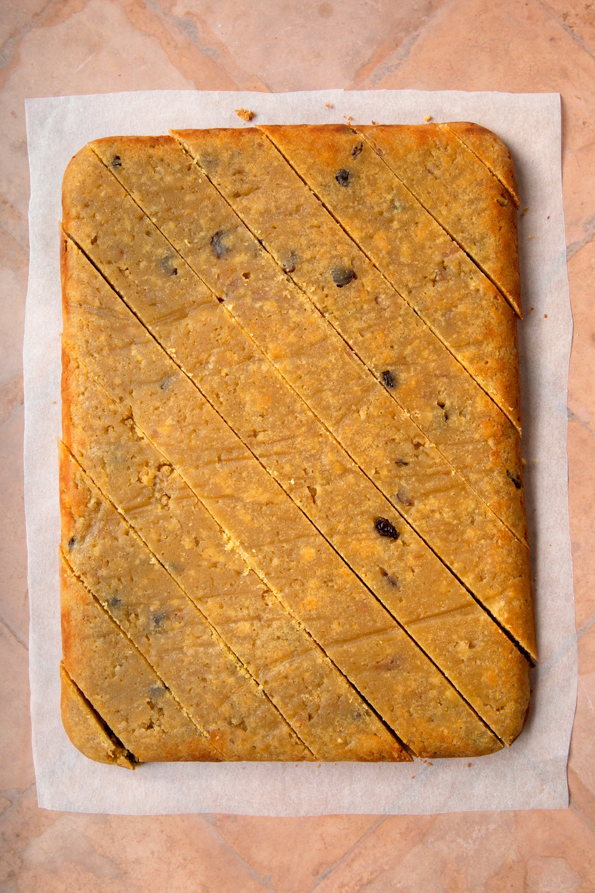Sanwin makin cake turned out onto baking paper and cut diagonally.