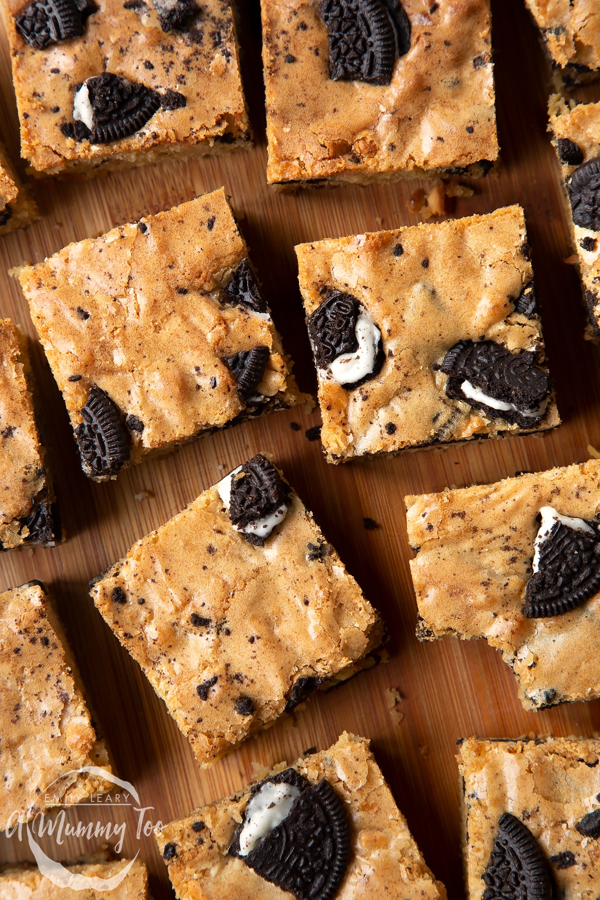 Overhead shot of square Oreo Blondies on a wooden board with the A Mummy Too logo in the corner