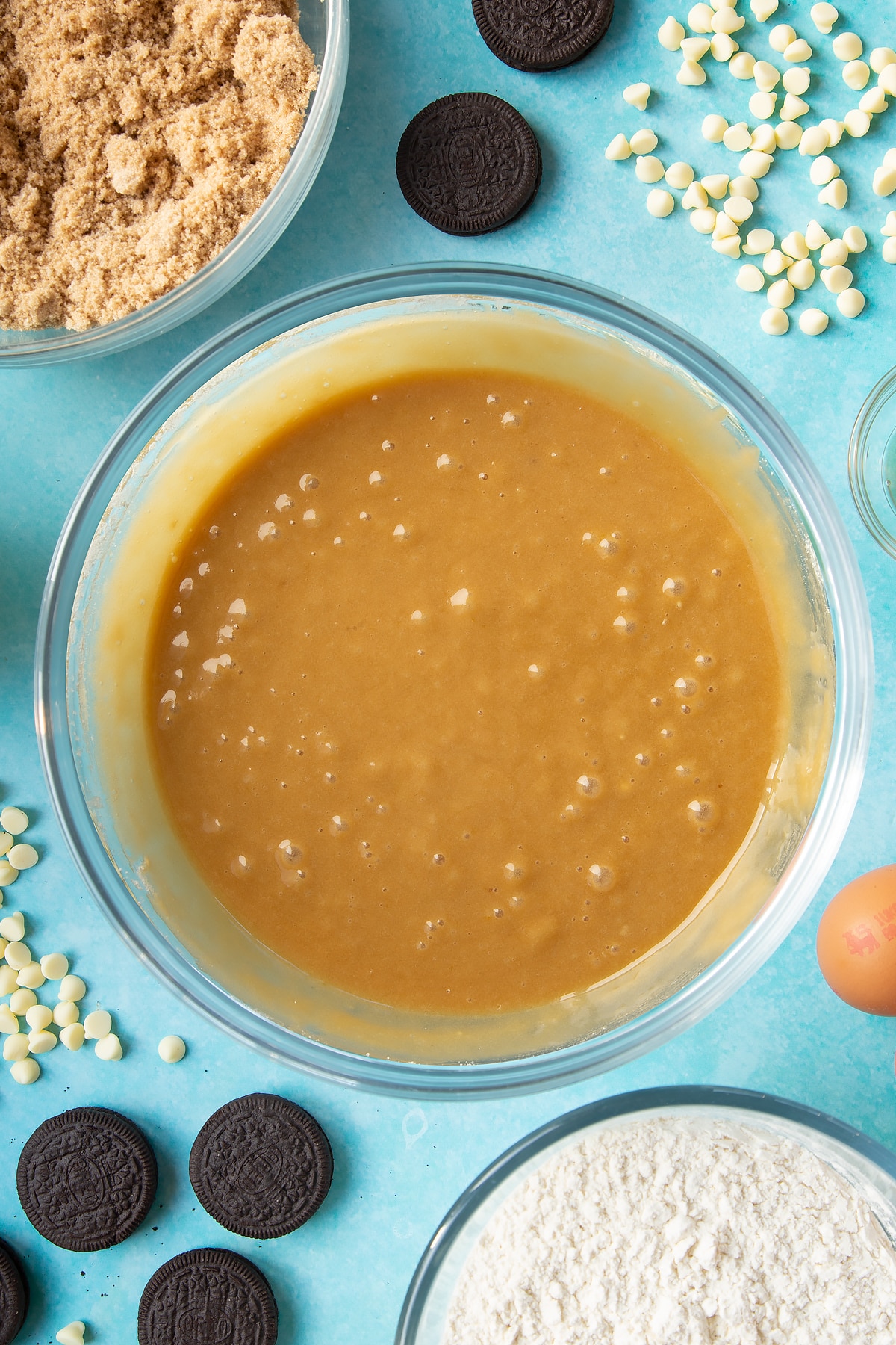 Overhead shot of butter and flour mixed in a large clear bowl
