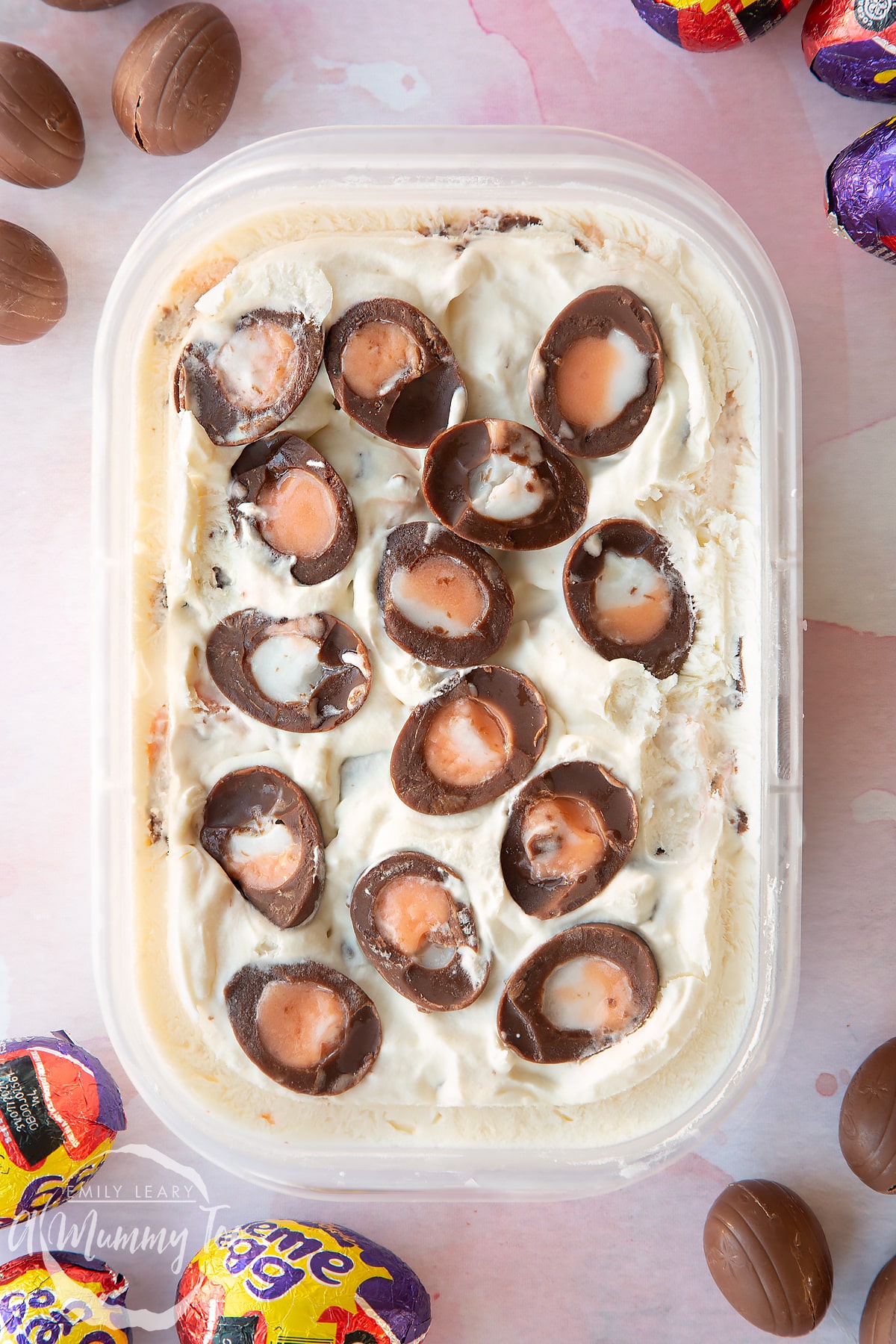 Creme Egg ice cream frozen in oblong plastic container.