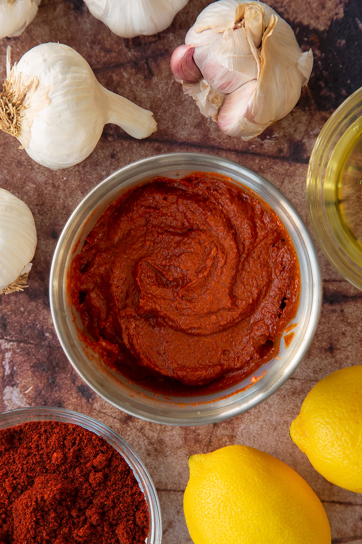 Overhead shot of puree'd garlic and spices mixed in a metal grinder