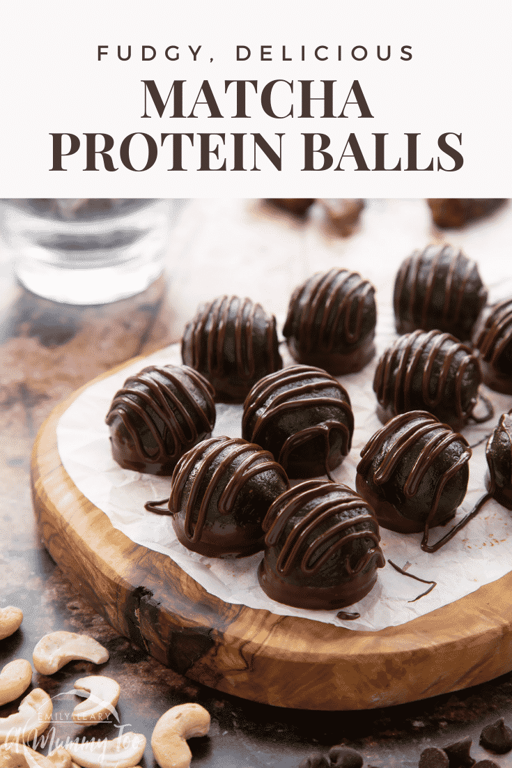 Close up of matcha protein balls on a wooden board lined with baking paper. Caption reads: fudgy, delicious matcha protein balls.