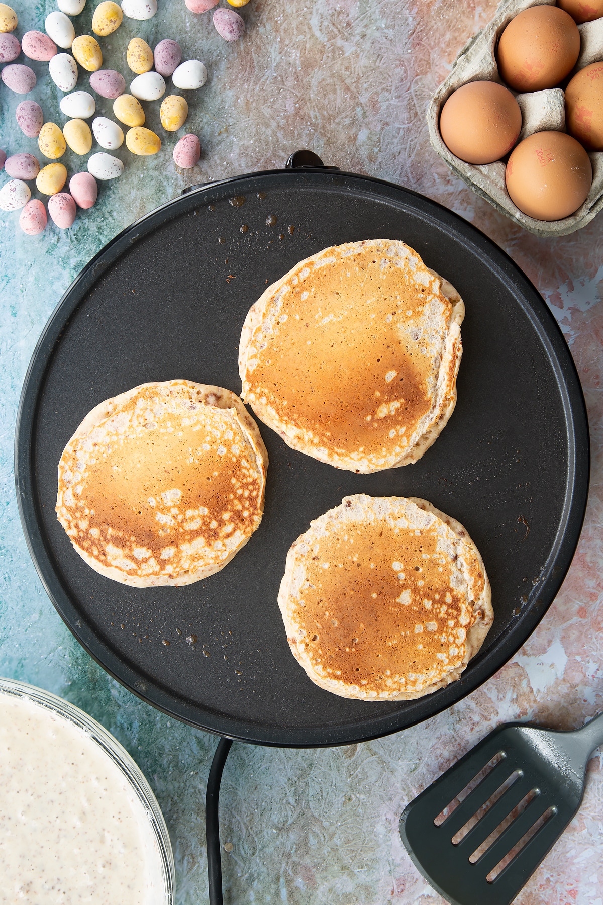 Freshly cooked Mini Egg pancakes on a hot pan.