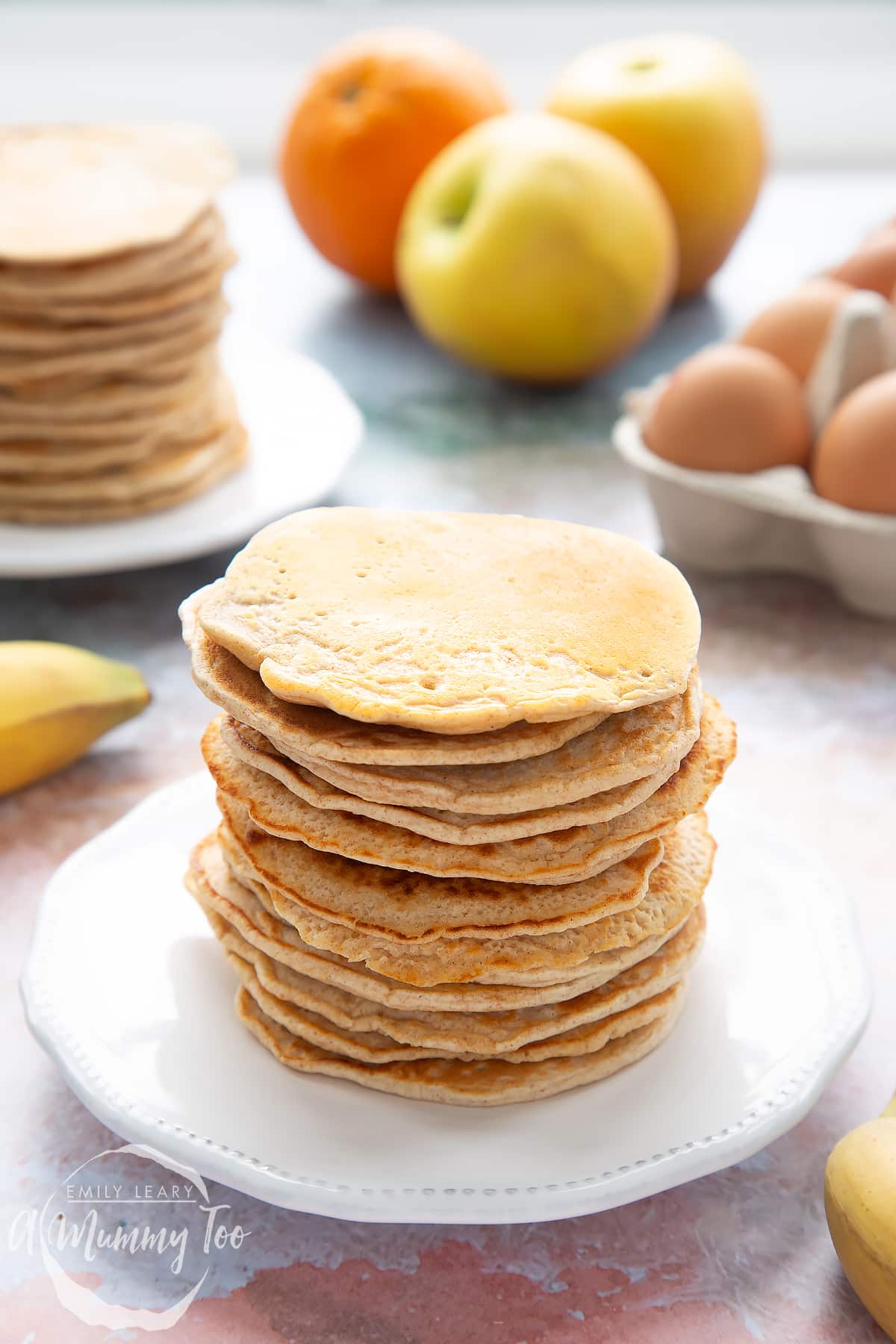Overhead shot of a pancake stack on a white plate with the A Mummy Too logo in the corner