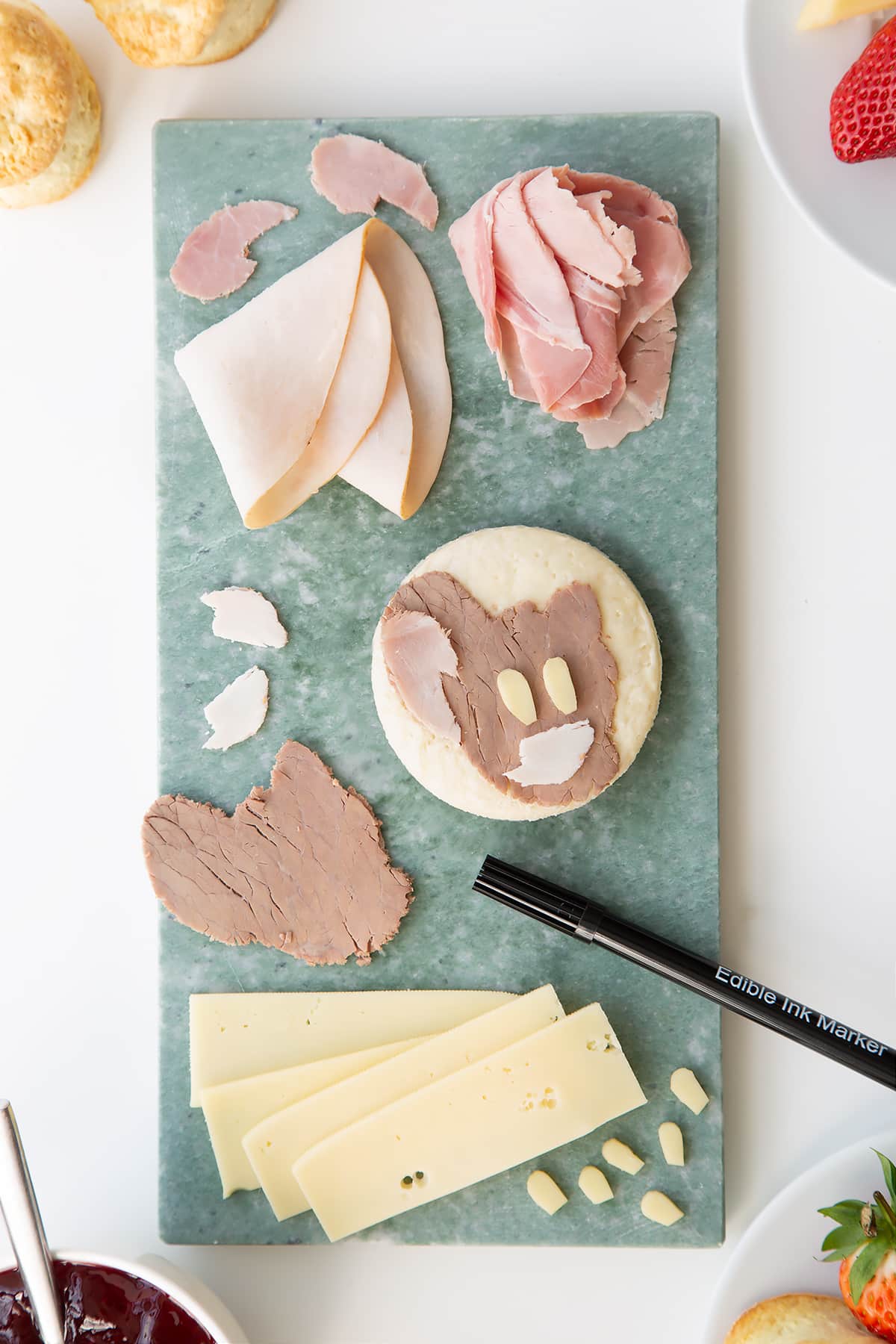 Overhead shot of the ingredients for a Tom and Jerry being assembled on a green chopping board.