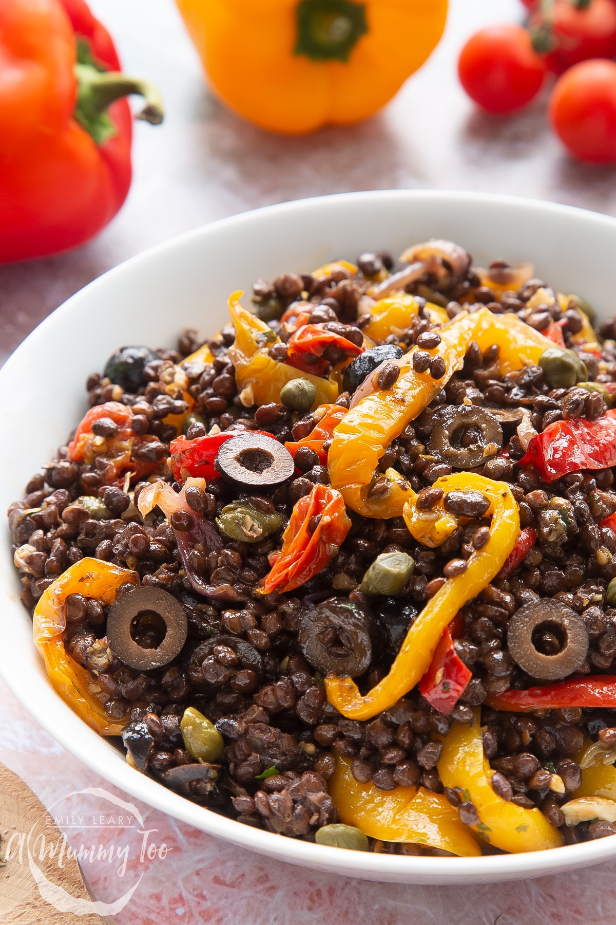 Close up of vegan lentil salad served in a white shallow bowl.