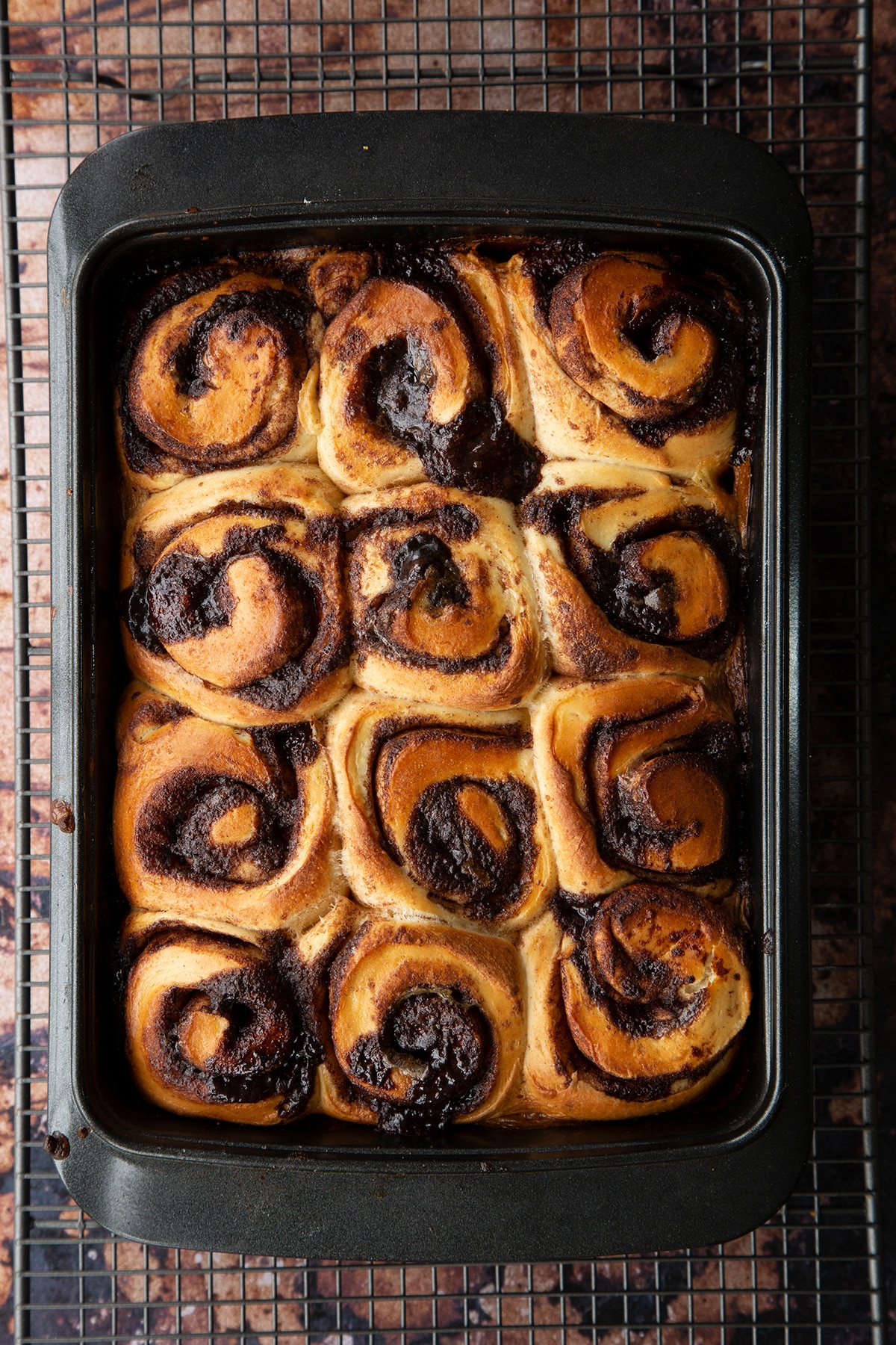 Overhead shot of chocolate cinnamon buns baked in a deep dish