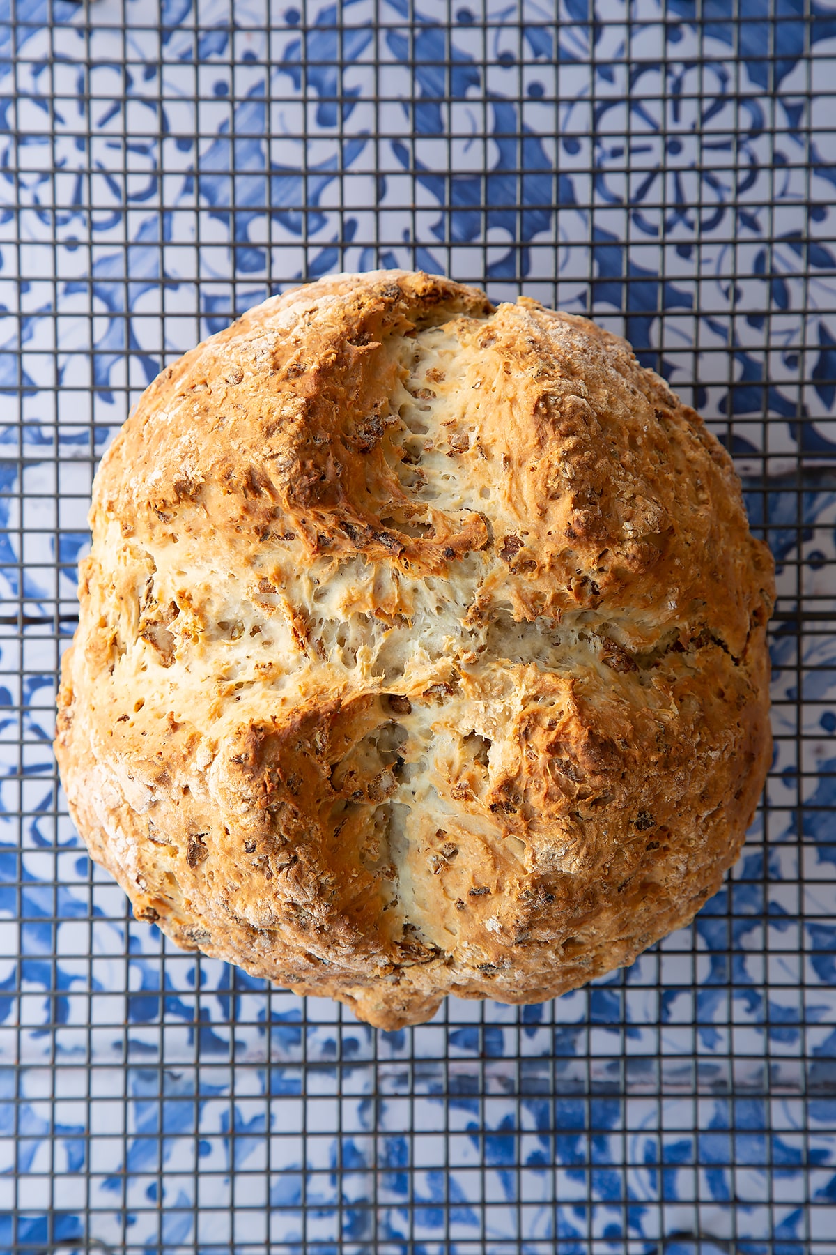 Freshly baked onion soda bread cooling on a wire rack.