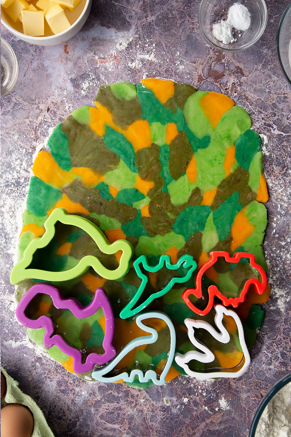 Overhead shot of small chunks of coloured cookie dough pieces laid out together on a surface