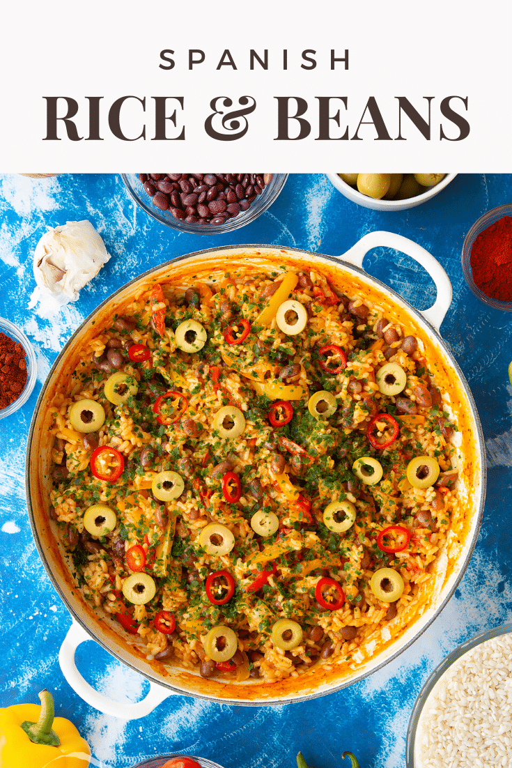 Easy Spanish rice and beans in a shallow white pot. Caption reads: Spanish rice and beans