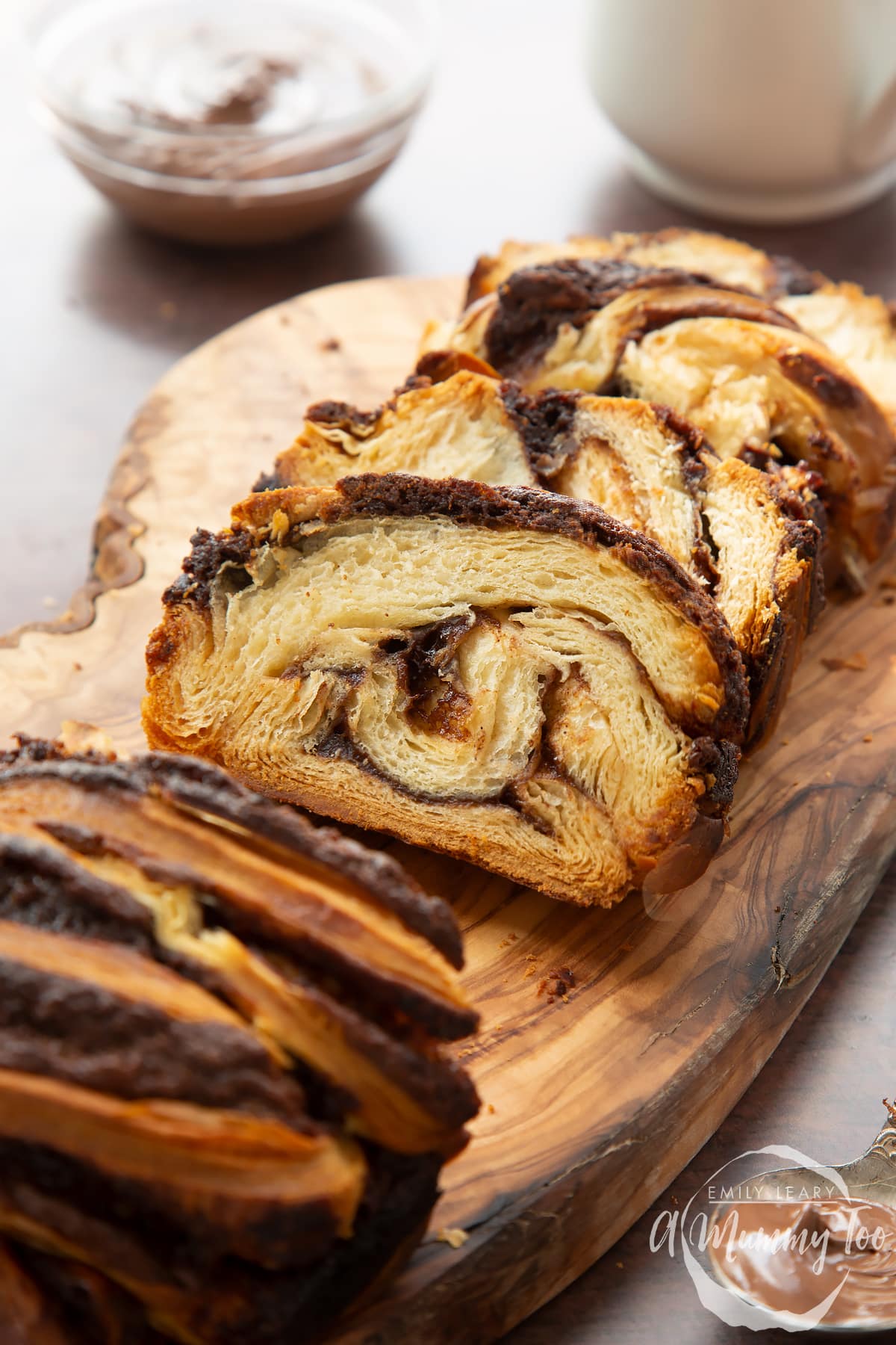 Slices of cinnamon swirl babka on a wooden board.