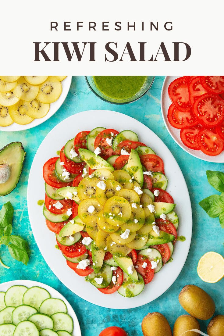 Kiwi feta salad on an oval white platter. Caption reads: Refreshing kiwi feta salad.
