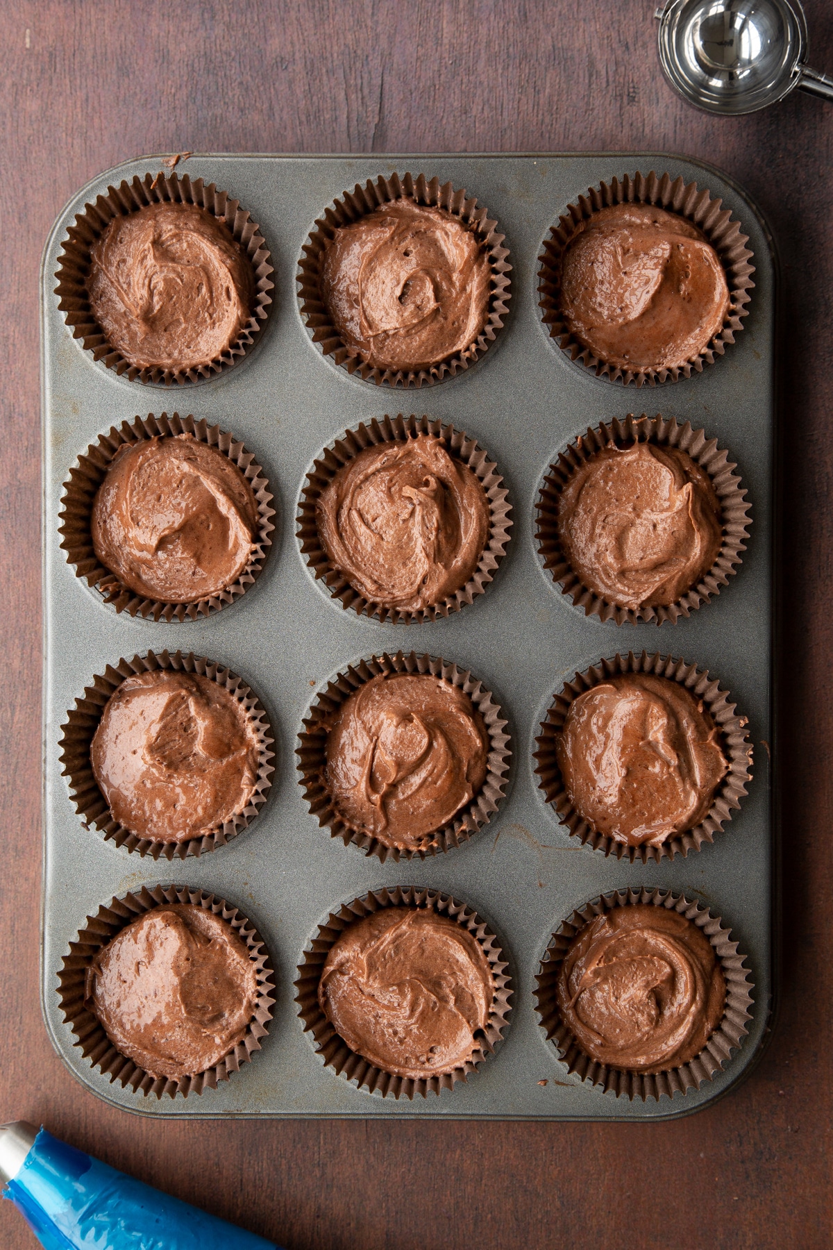 Baileys chocolate cupcakes batter in a 12 hole muffin tray.