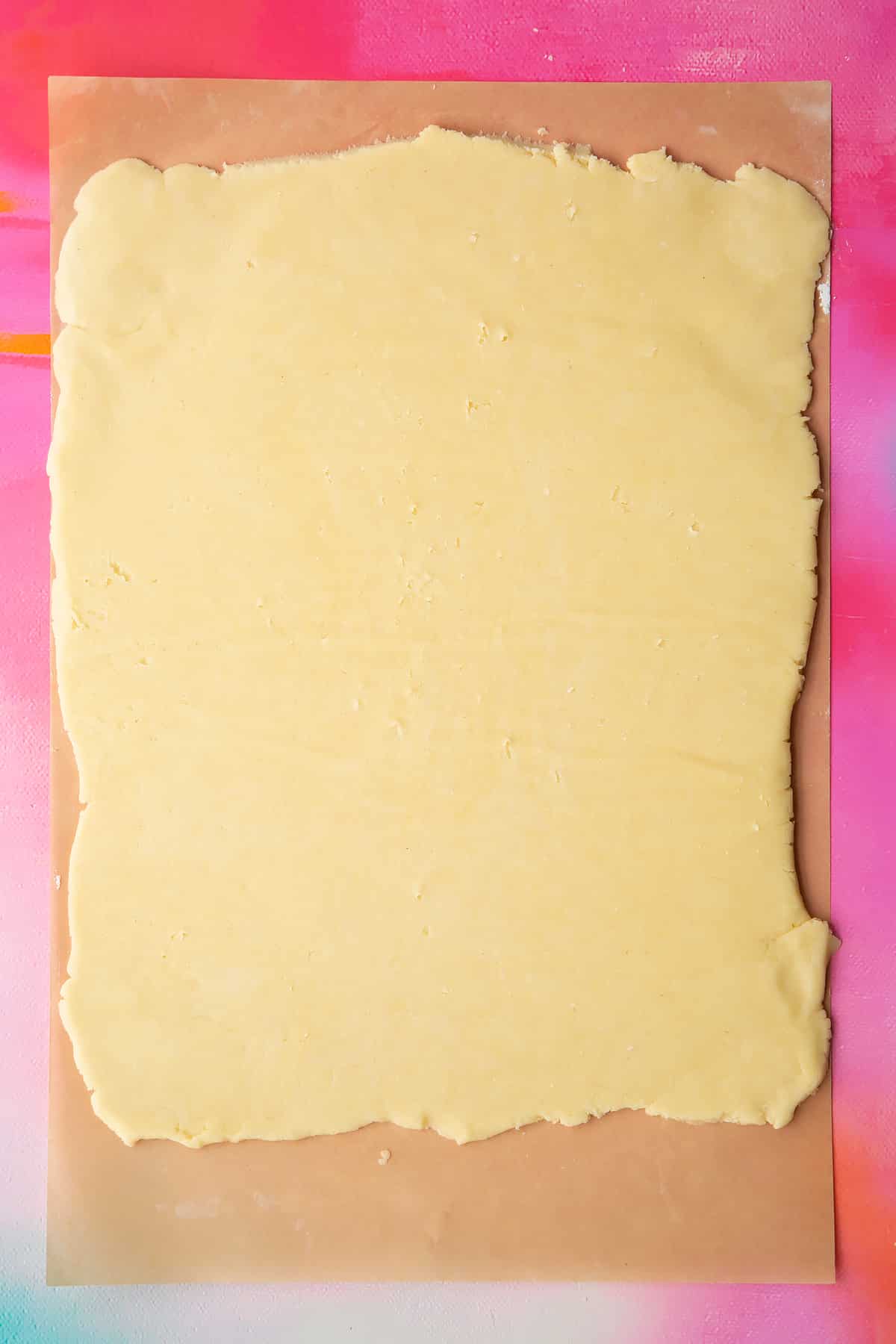 Gluten free pasty rolled out on a sheet of baking paper.