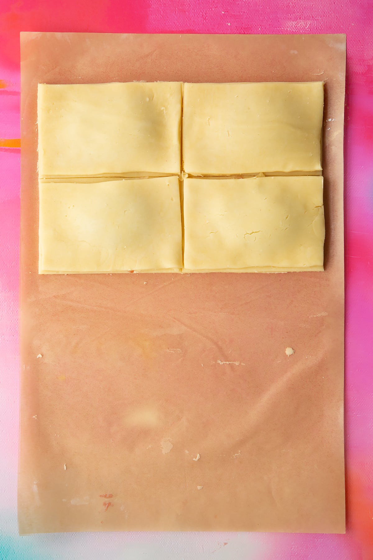 Four rectangles of gluten free pastry, topped with jam then 4 more rectangles of pastry.