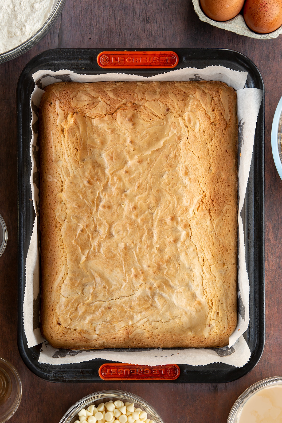 Freshly baked Baileys blondie in a lined tin.
