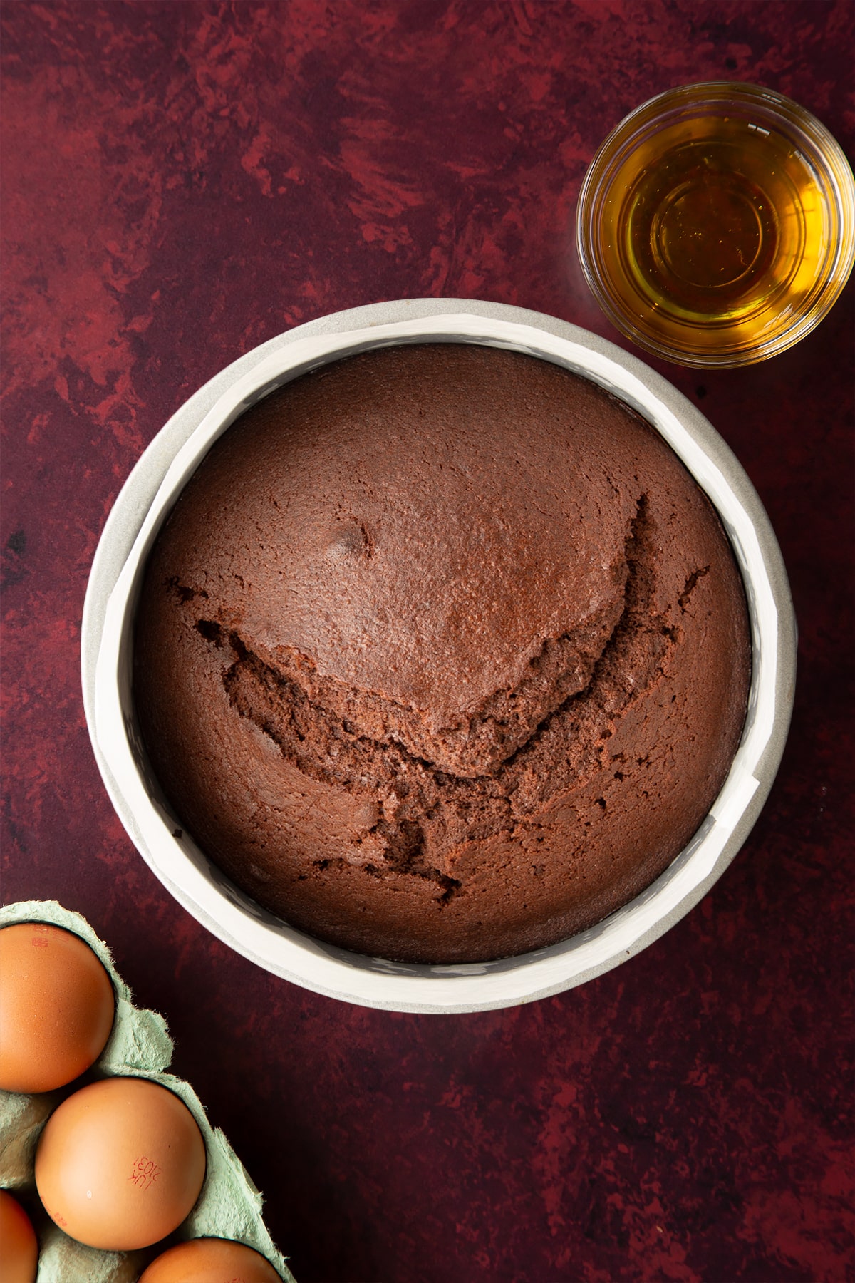Baked chocolate drizzle cake in a lined tin.