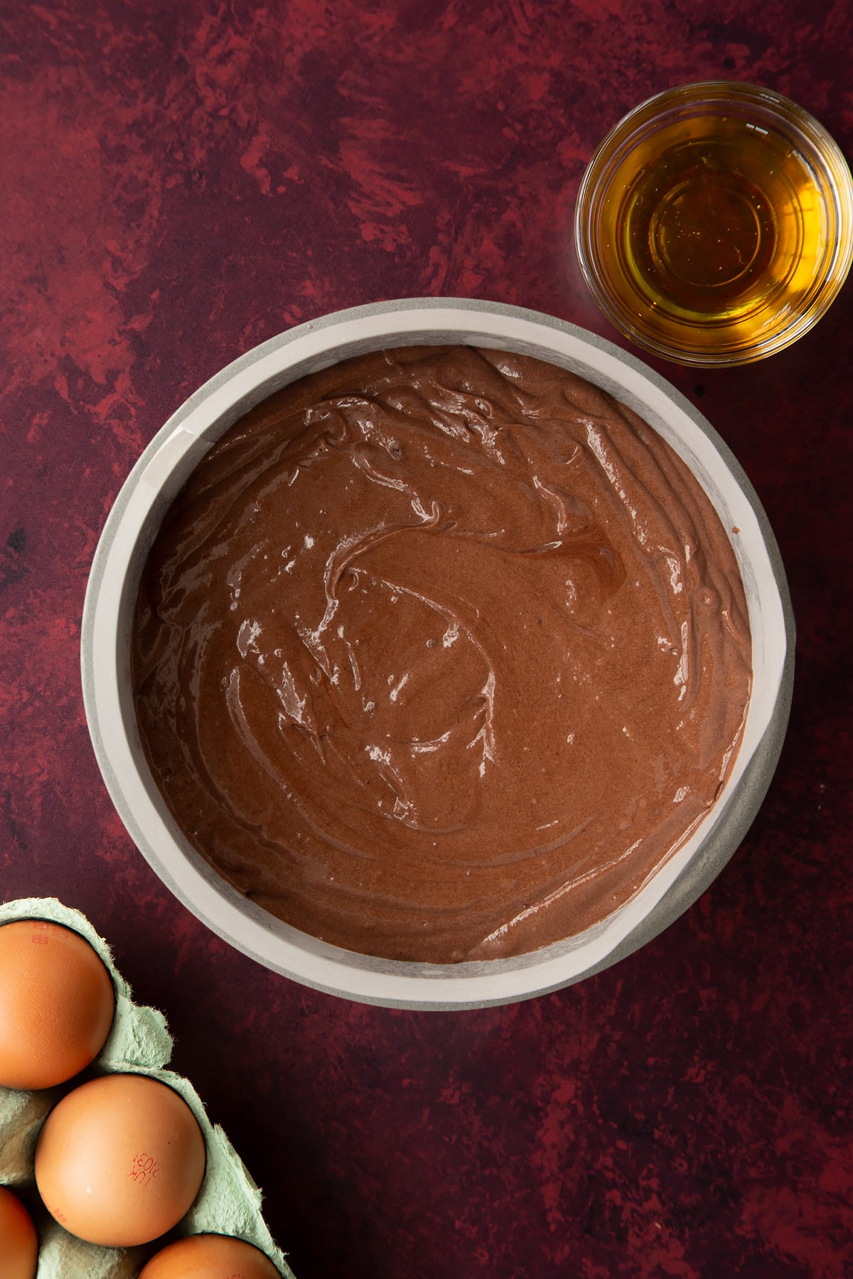 Chocolate drizzle cake batter in a lined tin.