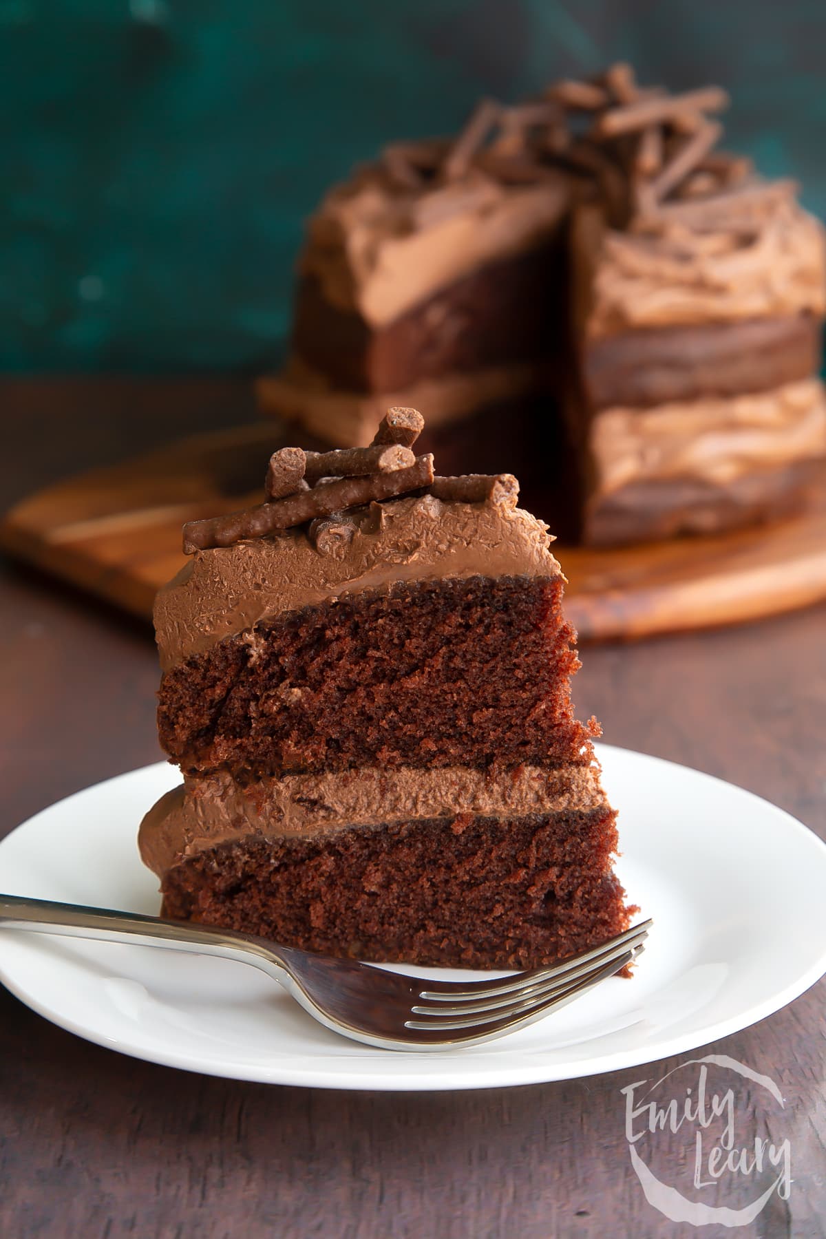 Slice of mint chocolate Matchmaker cake on a white plate with a fork.