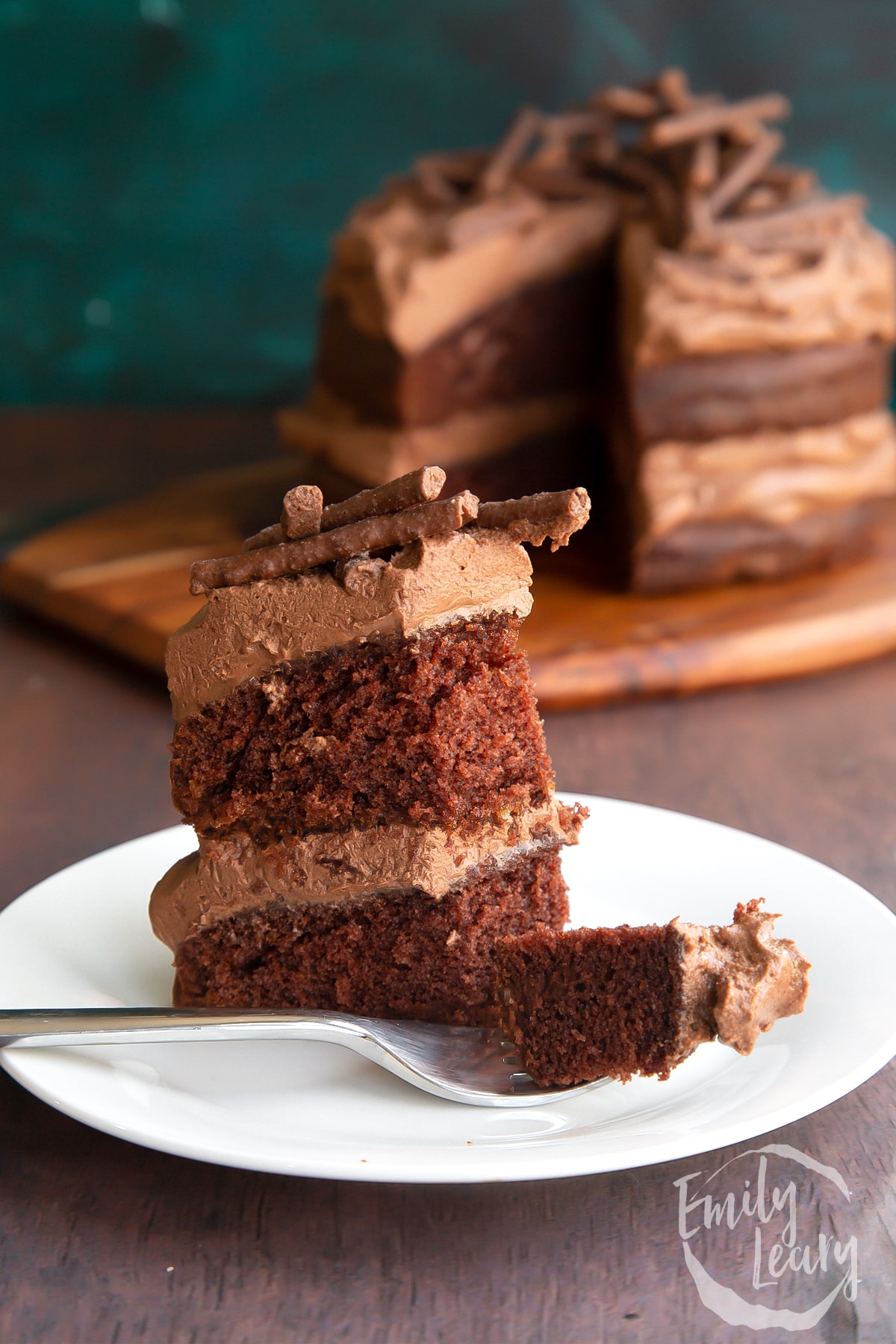 Slice of mint chocolate Matchmaker cake on a white plate. Some of the slice in on a fork.
